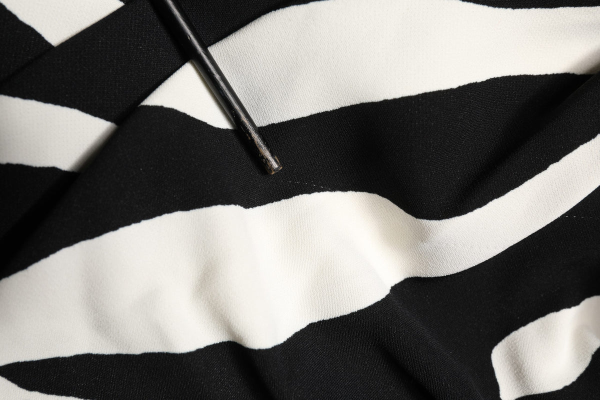 Elevate your wardrobe with the Dolce & Gabbana Black White Zebra Print Cady Dress, a masterpiece of Italian craftsmanship that embodies timeless elegance and allure.