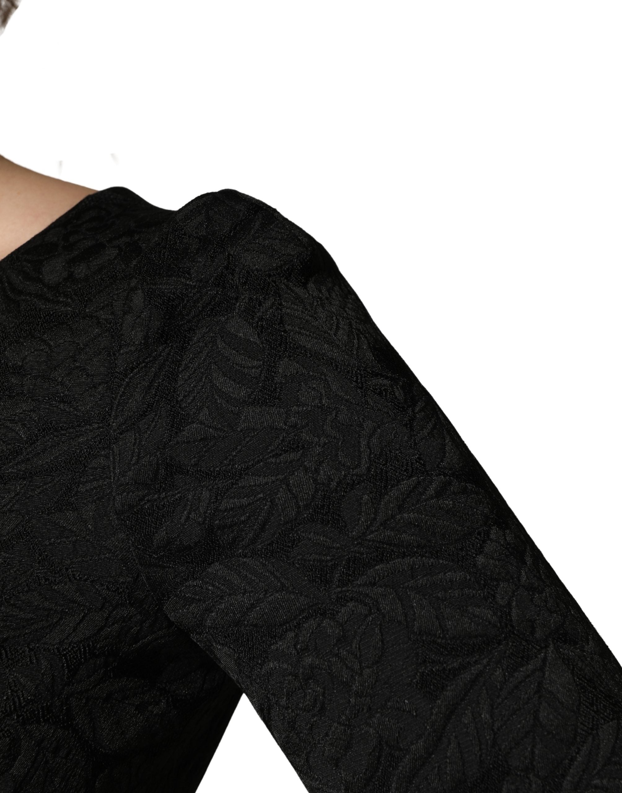 Indulge in the exquisite allure of the Dolce & Gabbana Black Floral Brocade Sheath Dress, a masterpiece of Italian craftsmanship that elevates any occasion with timeless elegance.