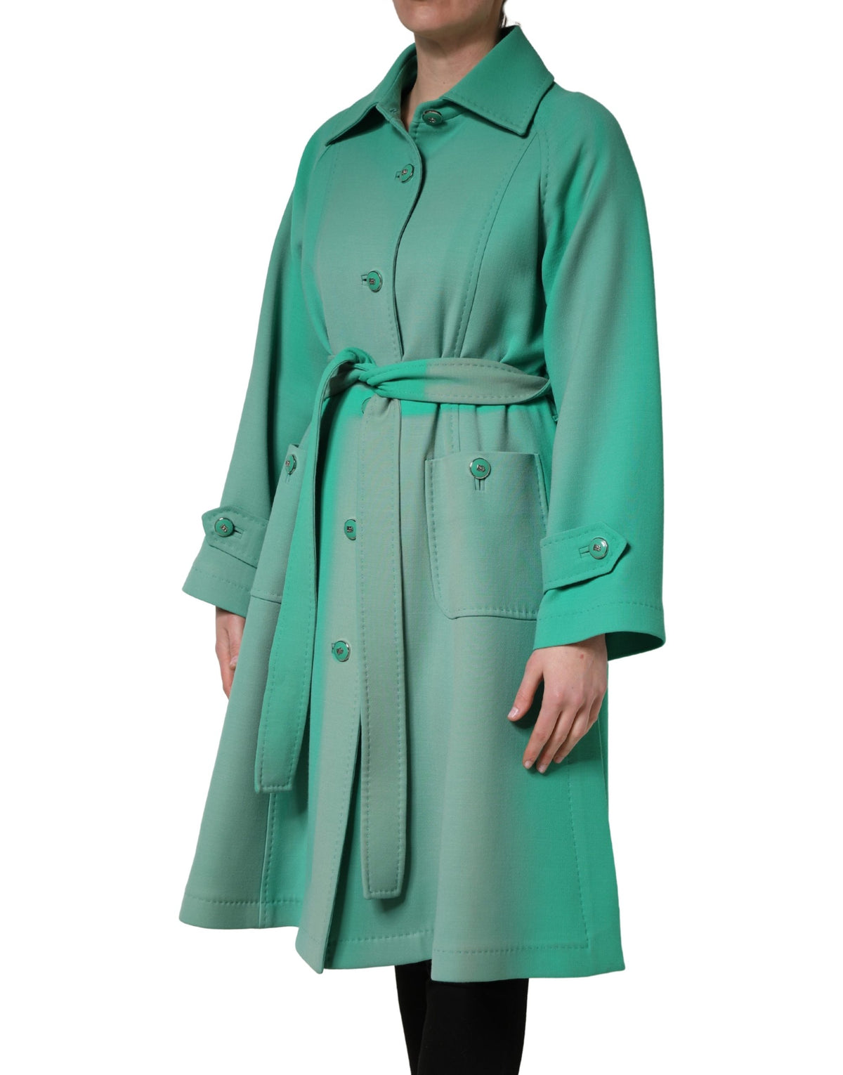 Indulge in the exquisite Dolce & Gabbana Green Buttoned Down Belt Trench Coat, a timeless masterpiece of 100% virgin wool that embodies luxury and sophistication.