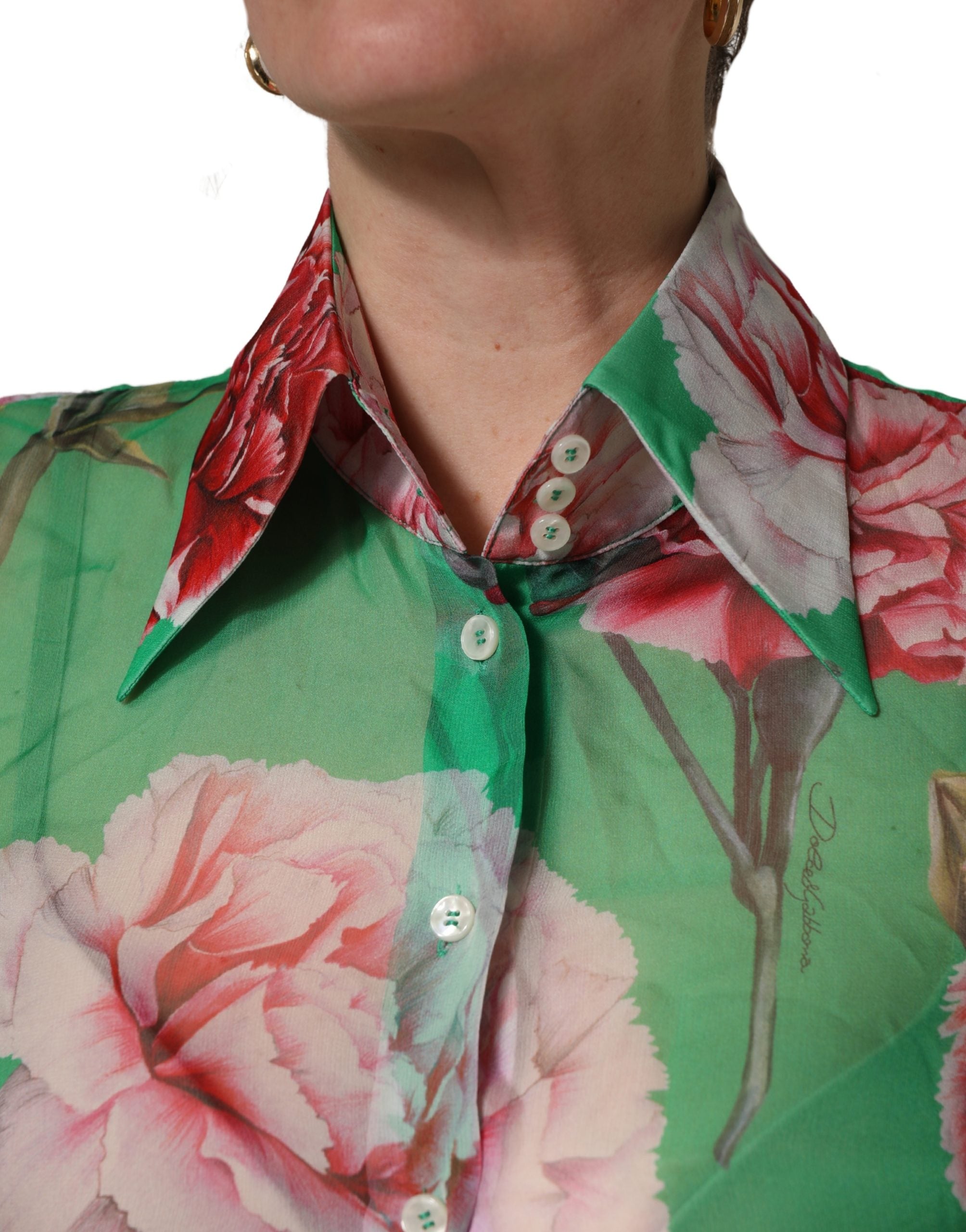 Indulge in the exquisite Dolce & Gabbana Green Carnation Print Silk Blouse, a masterpiece of Italian craftsmanship that embodies timeless elegance and sophisticated allure.