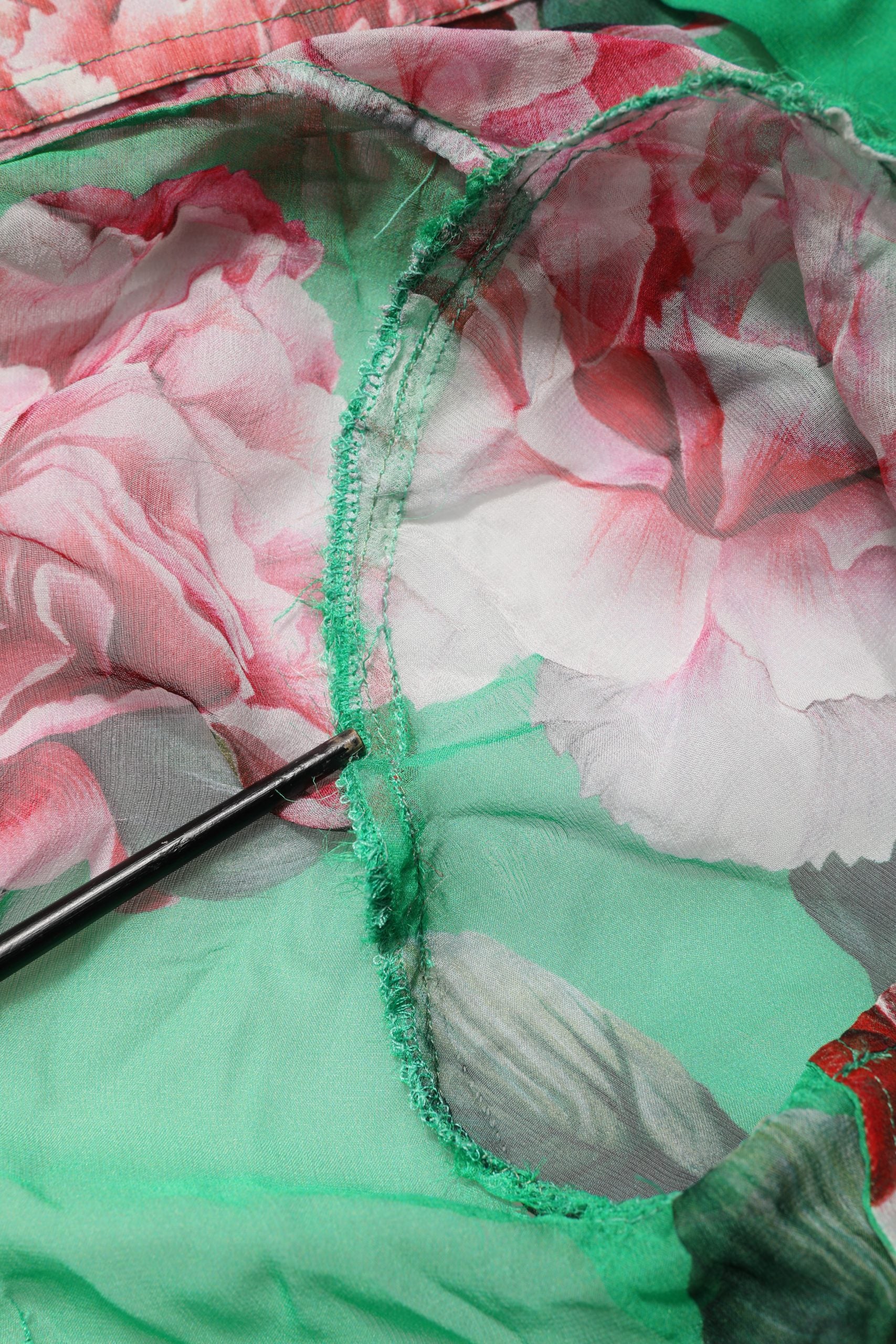 Indulge in the exquisite Dolce & Gabbana Green Carnation Print Silk Blouse, a masterpiece of Italian craftsmanship that embodies timeless elegance and sophisticated allure.