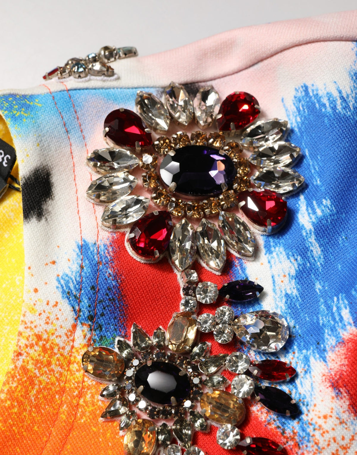 Discover the exquisite Dolce & Gabbana Multicolor Graffiti Crystals Crop Jersey Top, a luxurious blend of artistry and elegance, perfect for any sophisticated occasion.