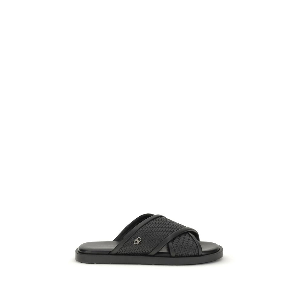 Indulge in the elegance of Ferragamo Black Calf Leather Bos Taurus Flat Sandals, where exquisite craftsmanship meets timeless luxury for effortless sophistication.