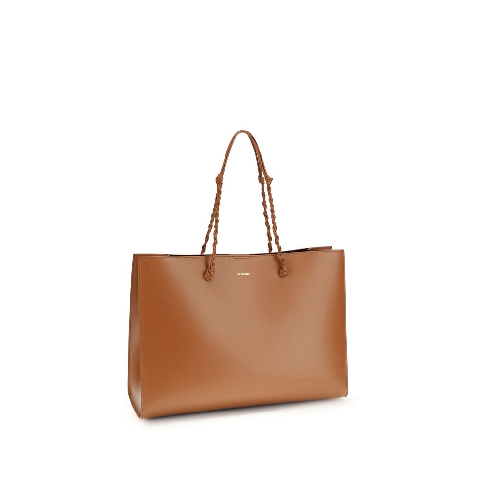 Indulge in the Jil Sander Brown Calf Leather Bos Taurus Shoulder Bag, a masterpiece of luxury craftsmanship, blending elegance and practicality for the discerning individual.
