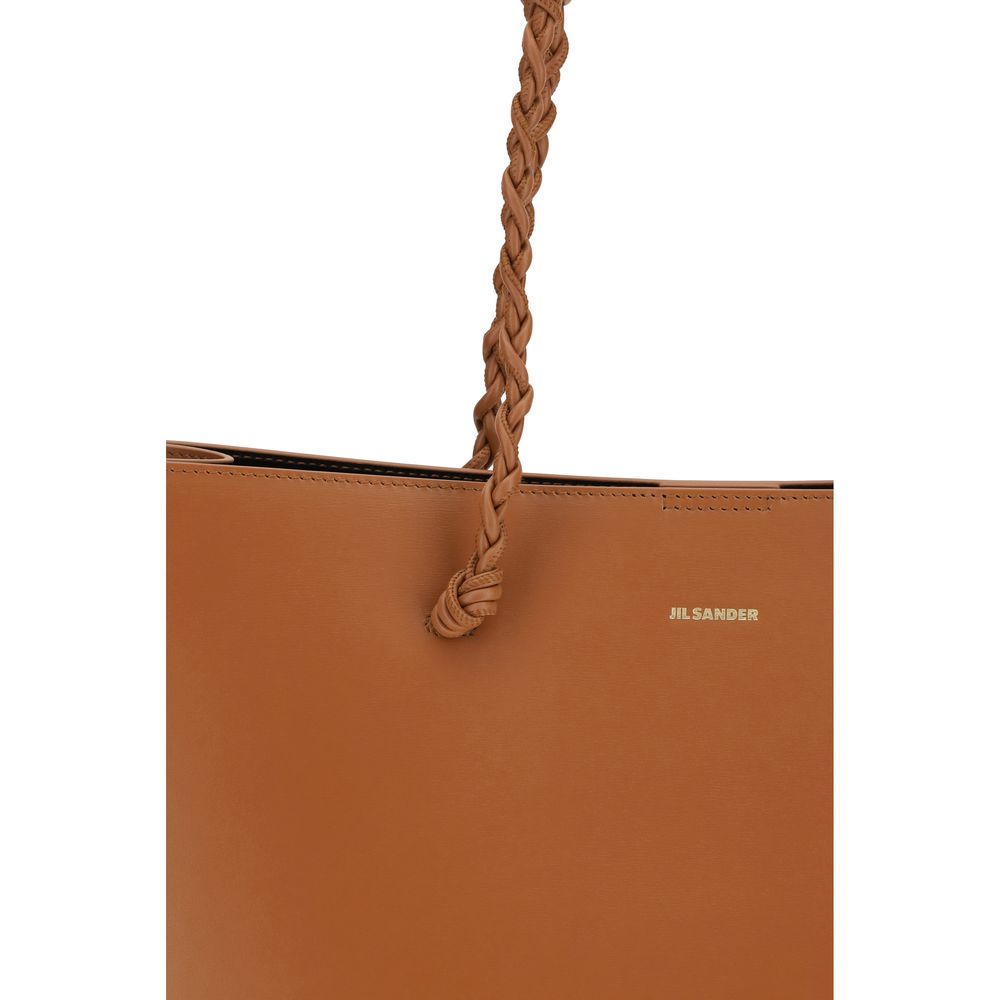 Discover the Jil Sander Brown Calf Leather Bos Taurus Shoulder Bag, a timeless blend of luxury and elegance, crafted for the discerning individual who appreciates refined artistry.