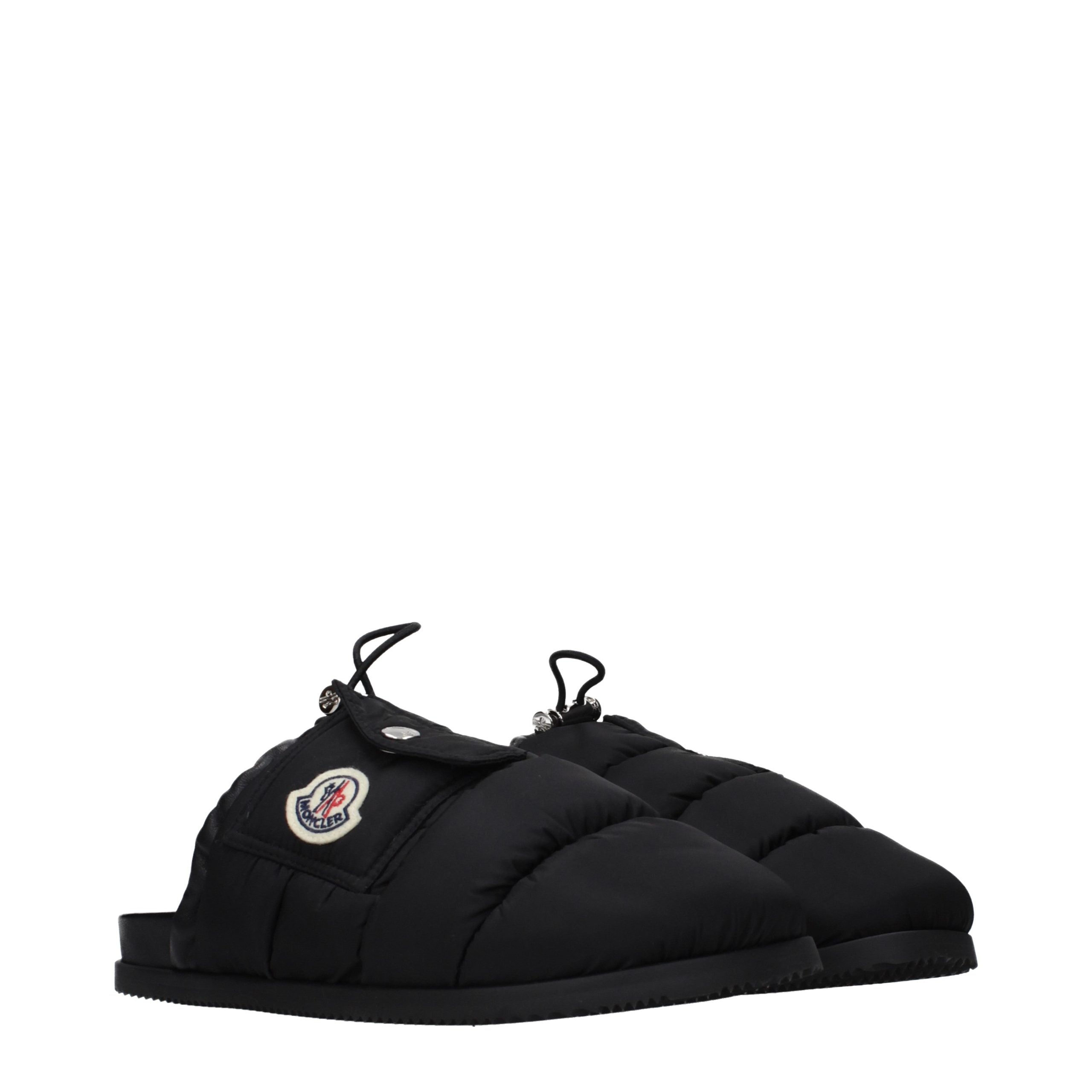 Indulge in the Moncler Black Fabric Slippers, where luxurious craftsmanship meets exquisite comfort, perfect for those who embody elegance and sophistication.