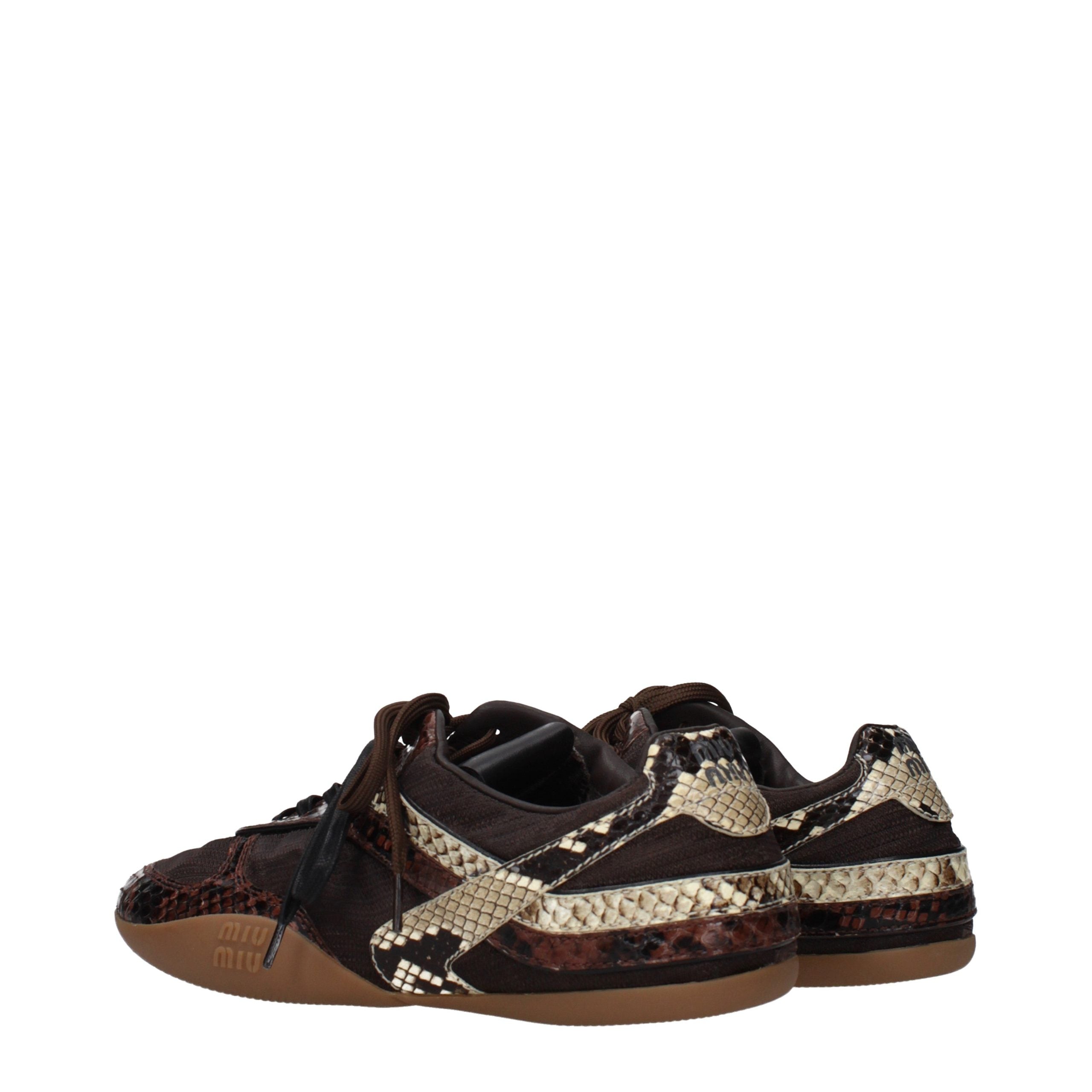 Elevate your style with Miu Miu's Brown Fabric Low Top Sneakers, where exquisite craftsmanship meets luxurious allure, perfect for the discerning modern lover.