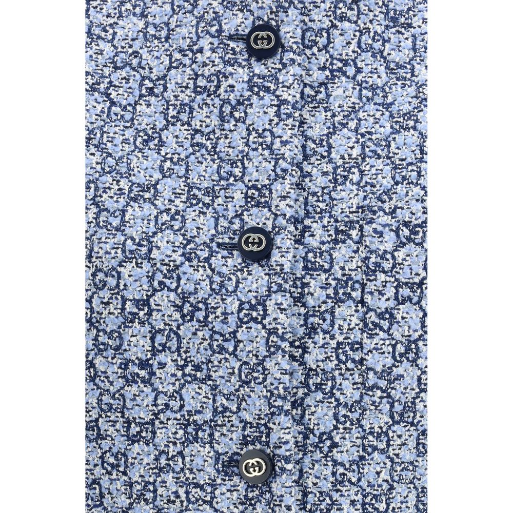 Elevate your wardrobe with the Gucci Blue Cotton Sleeveless Jacket, a luxurious GG tweed masterpiece that embodies timeless elegance and sophisticated versatility.