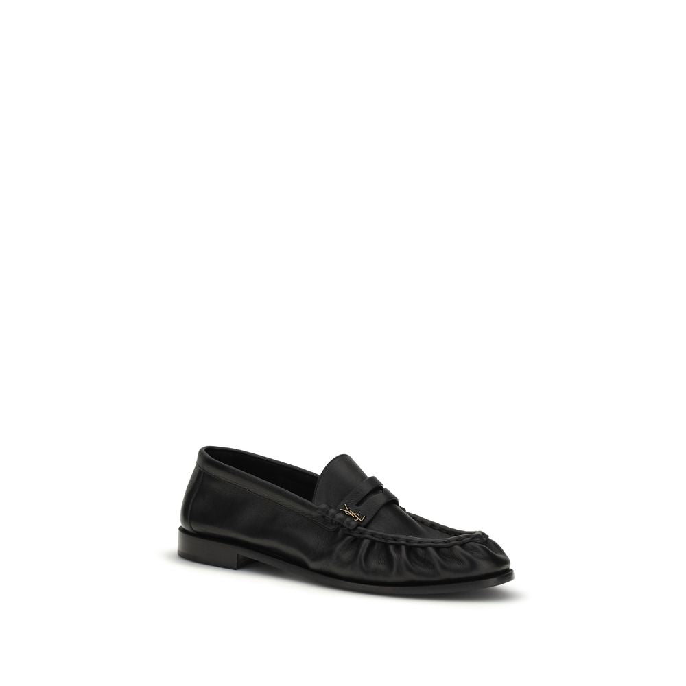 Indulge in the refined elegance of Saint Laurent's Black Calf Leather Bos Taurus Slip-On Loafers, where exquisite craftsmanship meets timeless sophistication for a striking statement.