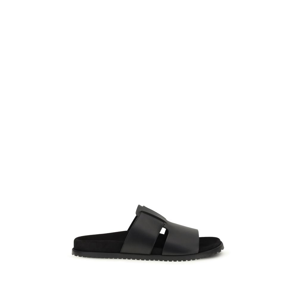 Experience the exquisite allure of Dolce & Gabbana's Black Calf Leather Bos Taurus Flat Sandals, where Italian craftsmanship meets timeless elegance for the discerning individual.