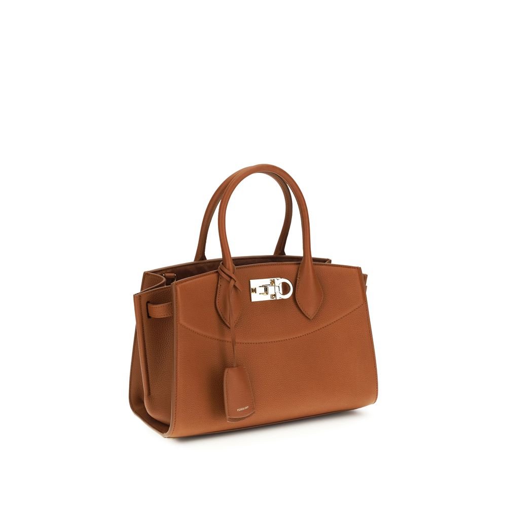 Indulge in the Ferragamo Brown Calf Leather Bos Taurus Shoulder Bag, a masterpiece of exquisite craftsmanship and timeless elegance, perfect for any occasion.