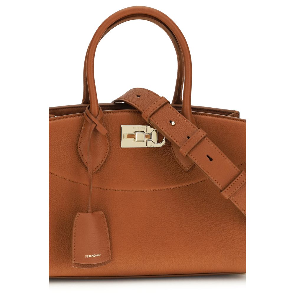 Discover the Ferragamo Brown Calf Leather Bos Taurus Shoulder Bag, a luxurious blend of exquisite craftsmanship and timeless design, perfect for any sophisticated occasion.