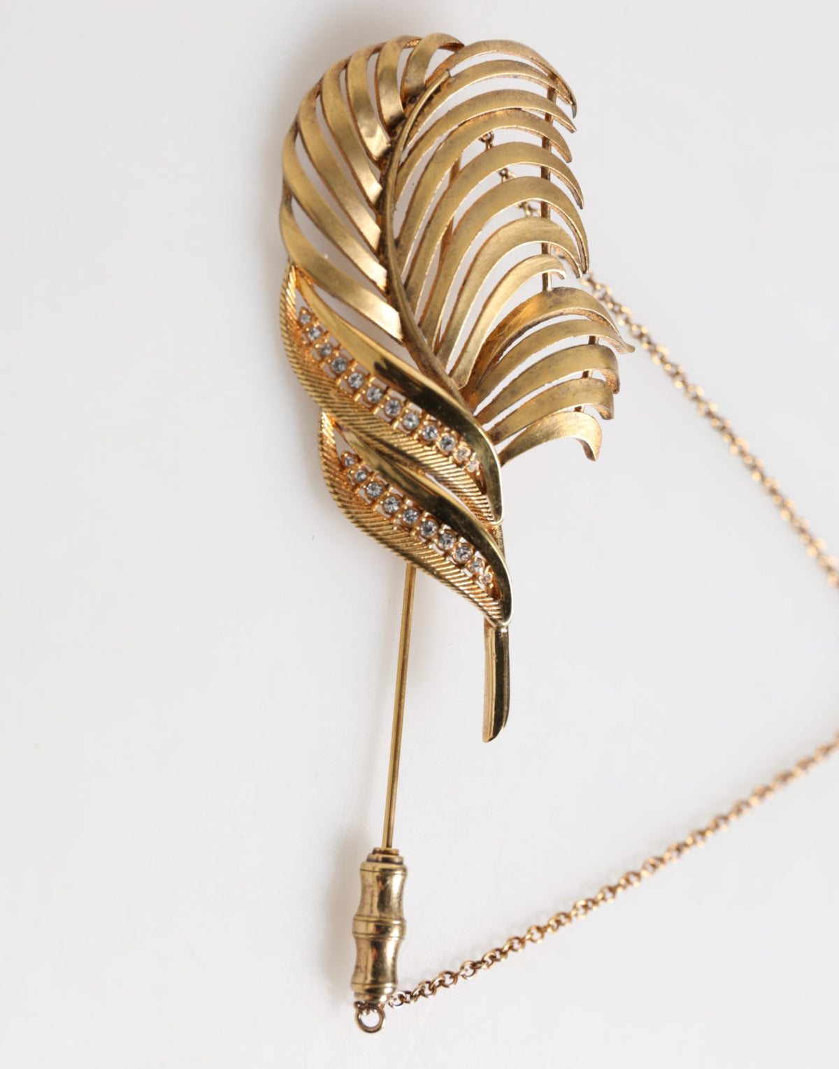 Discover the exquisite Dolce & Gabbana Gold Sterling Silver925 Leaf Embellished Lapel Pin Brooch, a luxurious statement piece that embodies elegance and artistry.