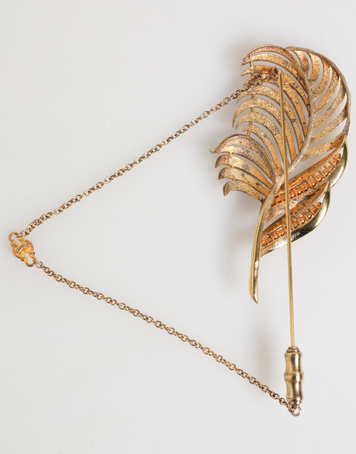Discover the exquisite Dolce & Gabbana Gold Sterling Silver925 Leaf Embellished Lapel Pin Brooch, a luxurious statement piece that embodies sophistication and artistry.