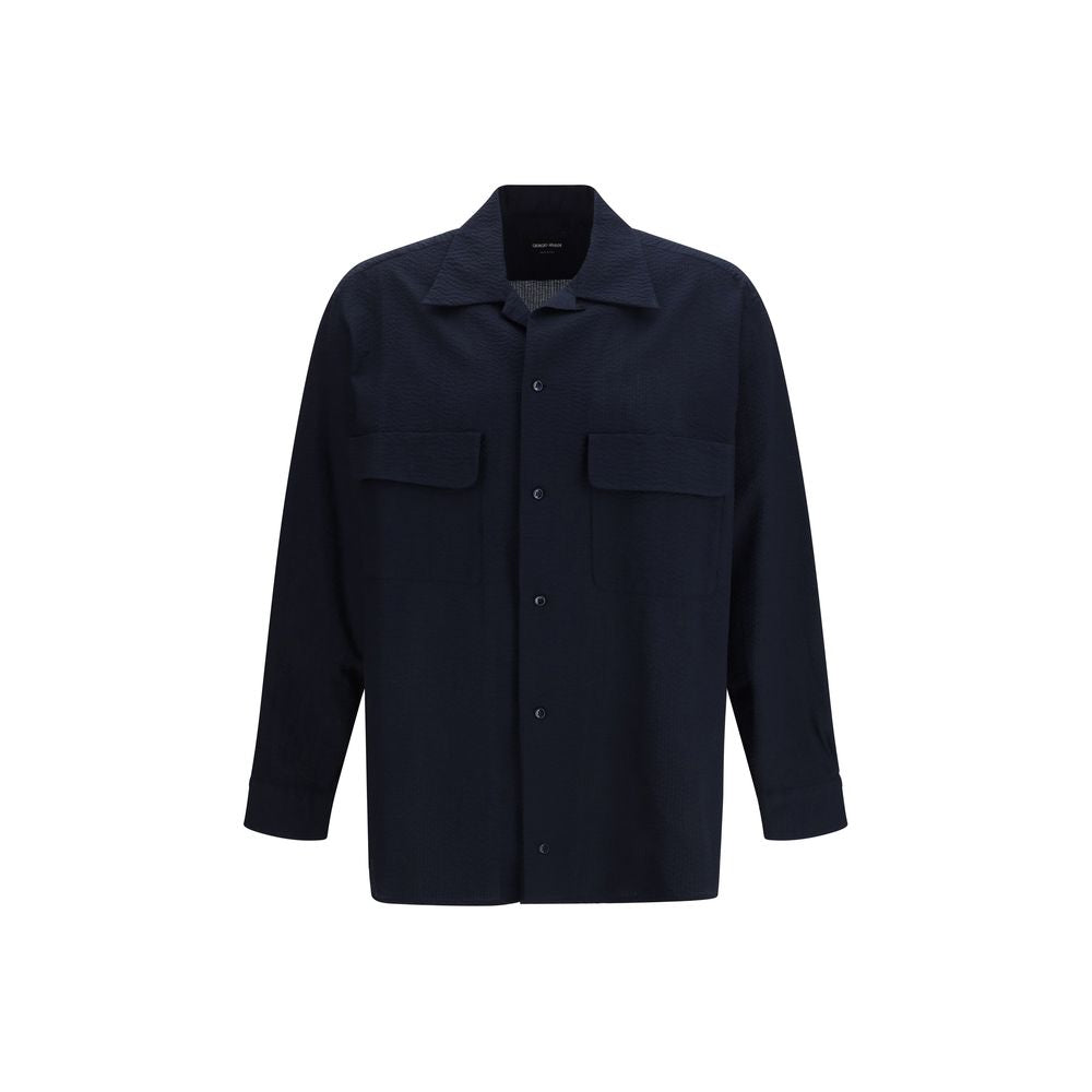 Discover the Giorgio Armani Blue Cotton Shirt, a masterpiece of refined craftsmanship in 100% cotton, embodying timeless elegance and effortless sophistication for any occasion.