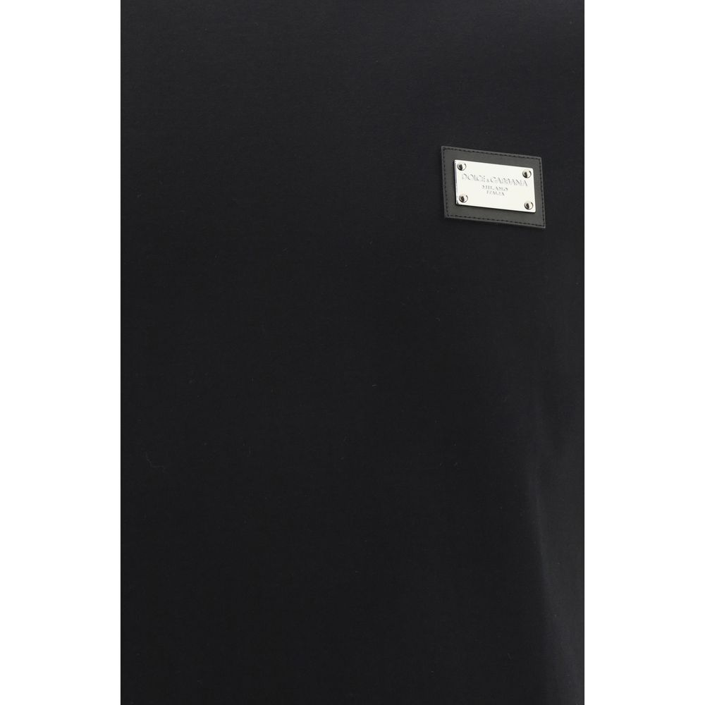 Indulge in the elegance of the Dolce & Gabbana Black Cotton T-Shirt, a masterpiece of comfort and style, crafted from 100% cotton for a luxurious fit.