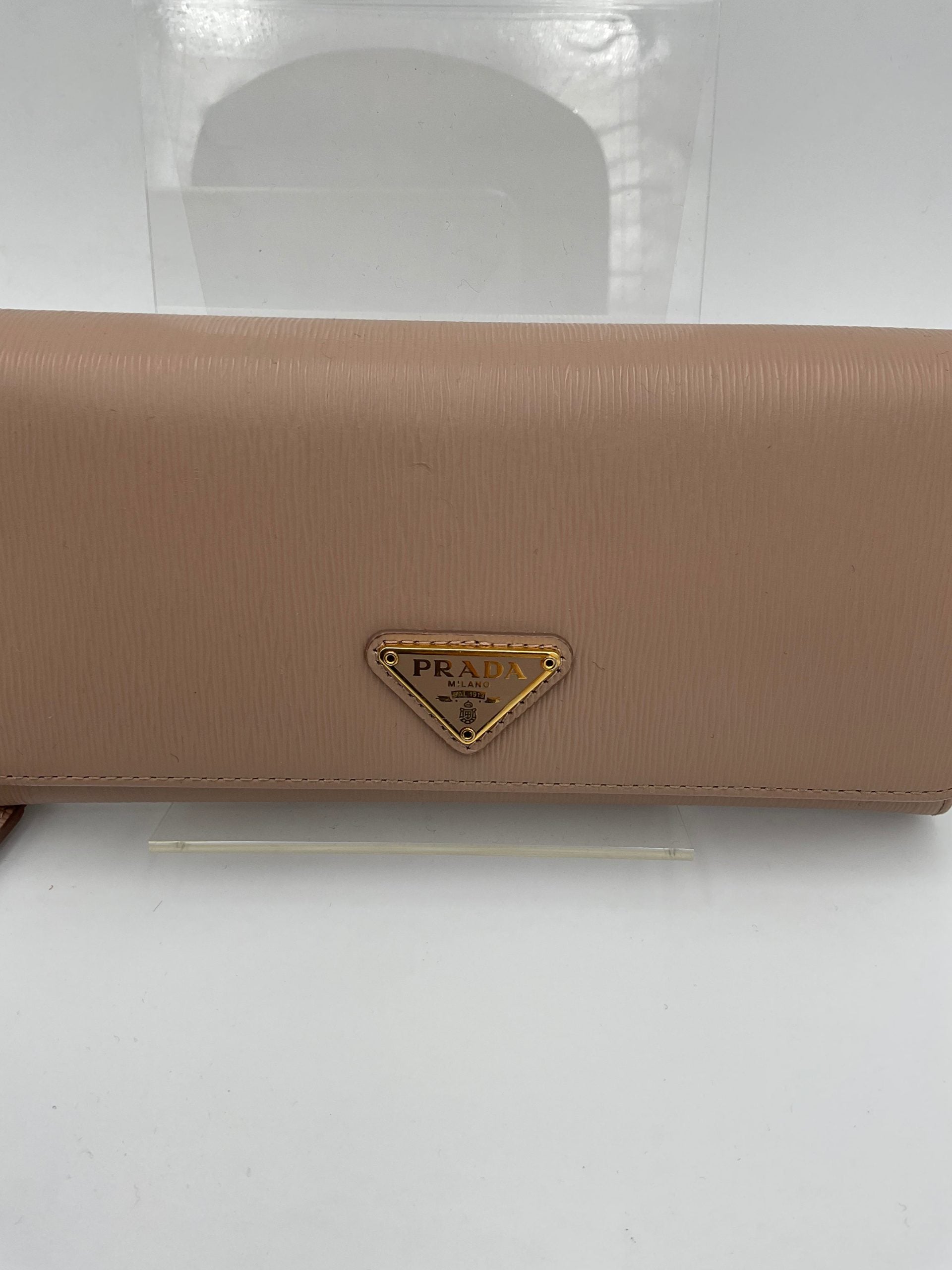 Discover the Prada PRADA Powder Saffiano Wallet, a symbol of luxury and sophistication, featuring exquisite craftsmanship and a chic card holder for the discerning individual.