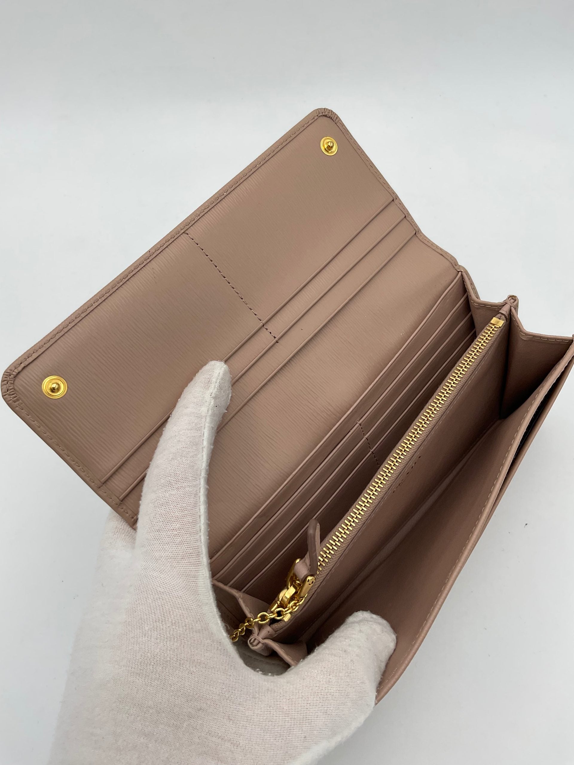 Indulge in the exquisite Prada PRADA Powder Saffiano Wallet, a testament to luxury and craftsmanship, designed for the discerning individual who values elegance and sophistication.
