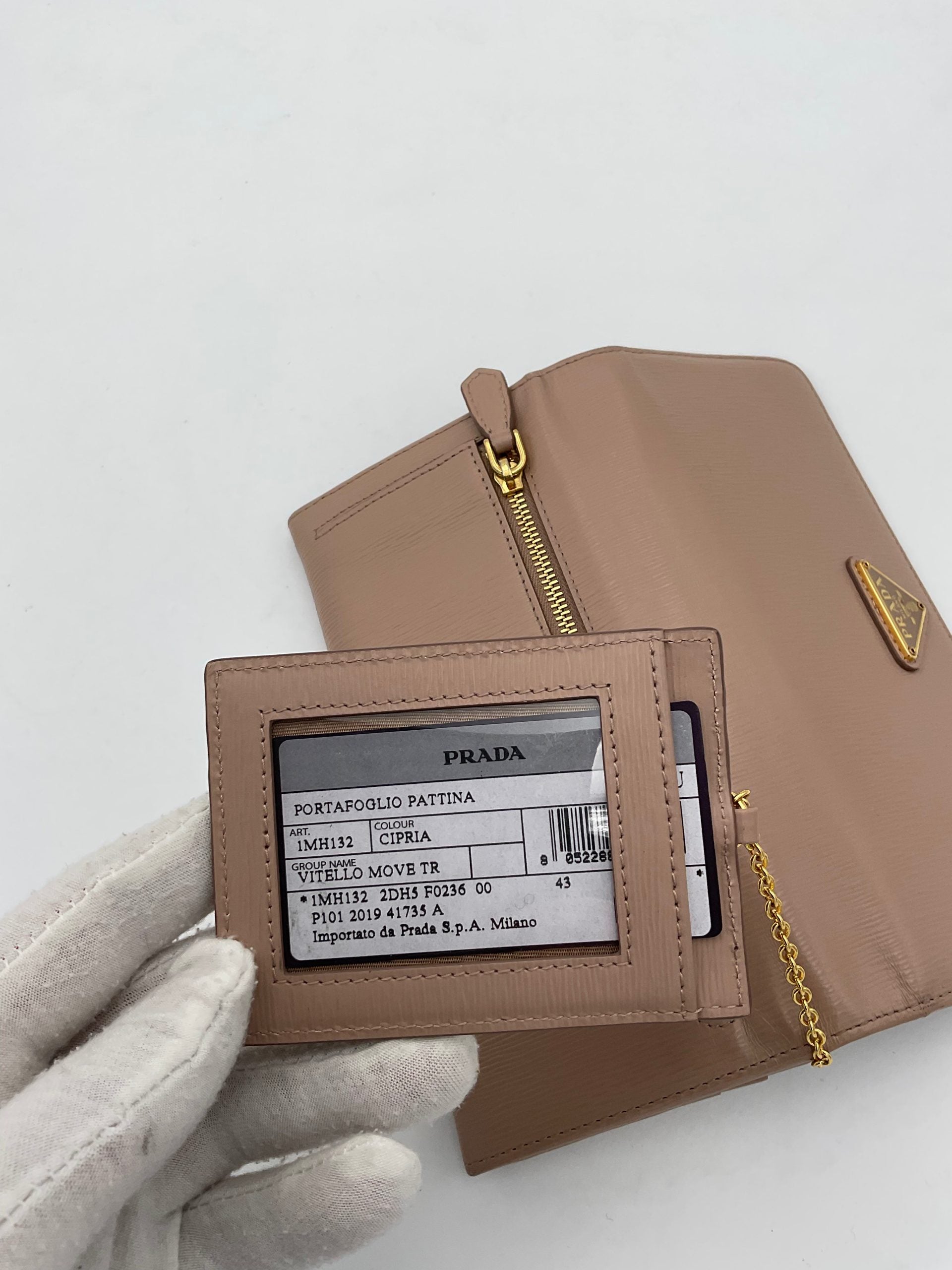 Discover the Prada PRADA Powder Saffiano Wallet, a symbol of luxury and sophistication, featuring exquisite craftsmanship and a convenient card holder for the discerning individual.