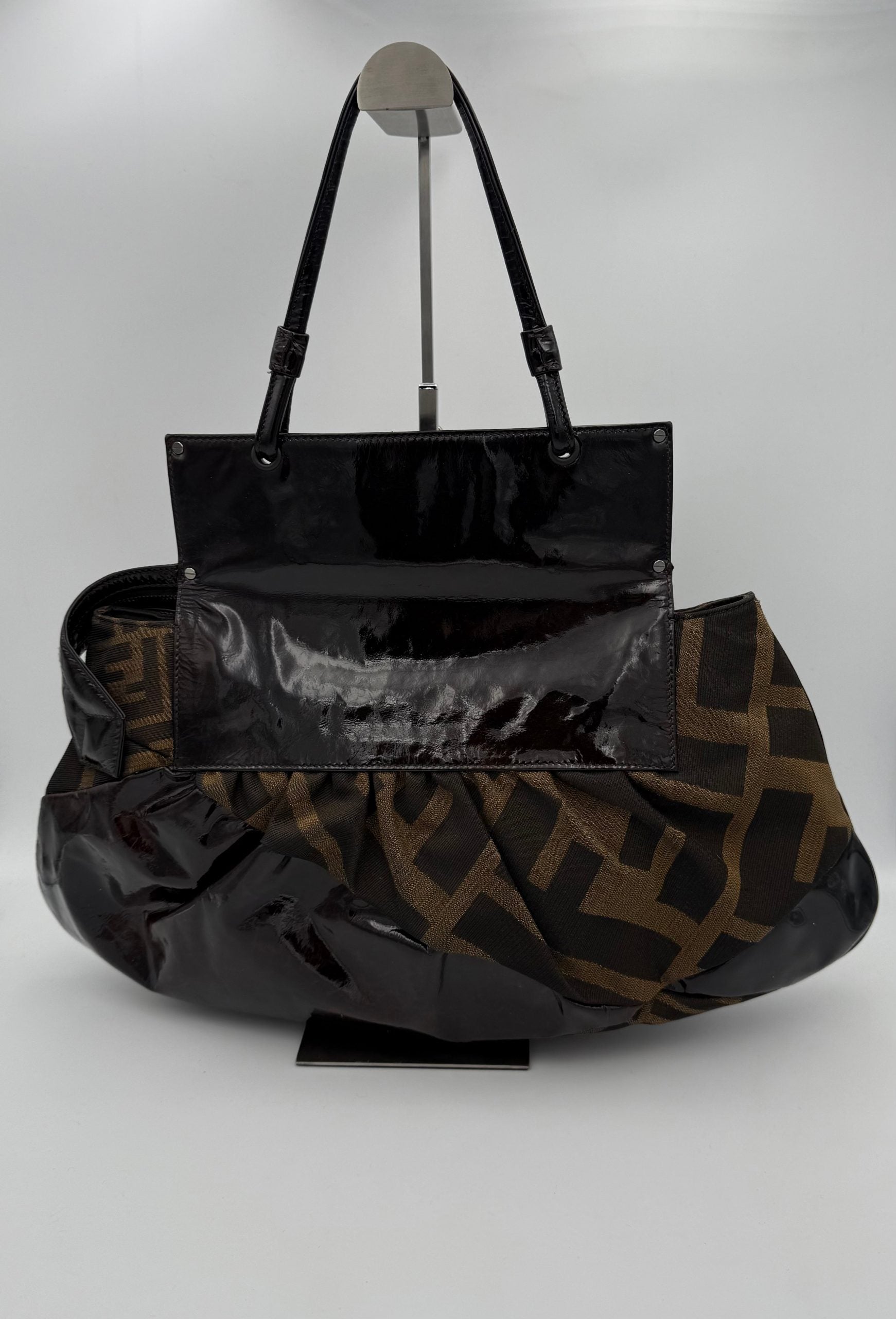 Elevate your style with the Fendi FENDI FF Zucca TO YOU Handbag, a symbol of exquisite craftsmanship and timeless elegance, perfect for any sophisticated ensemble.