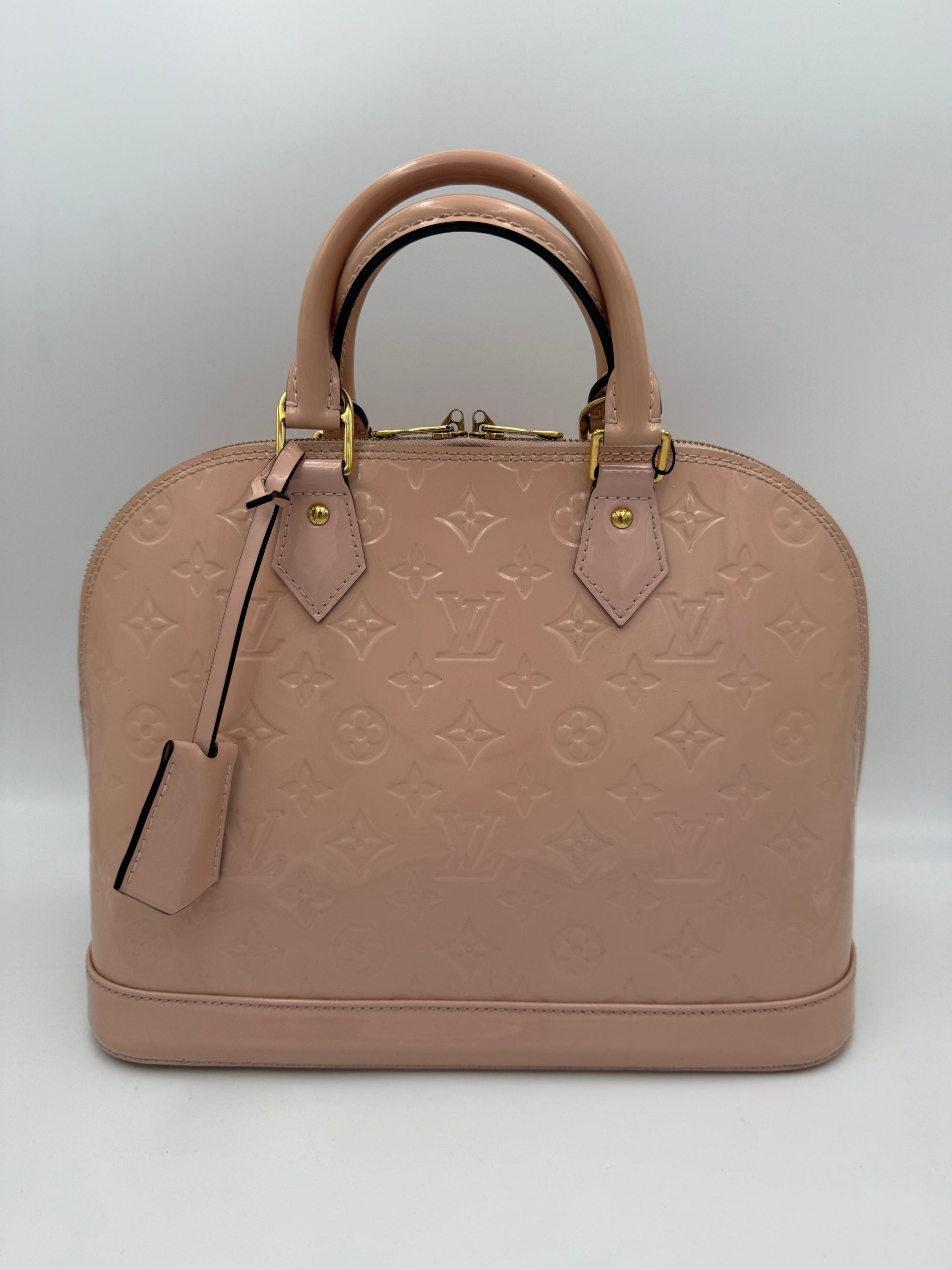 Indulge in the exquisite Louis Vuitton Alma MM Pink Patent Monogram Handbag, a timeless masterpiece that elevates your style with unparalleled craftsmanship and iconic allure.