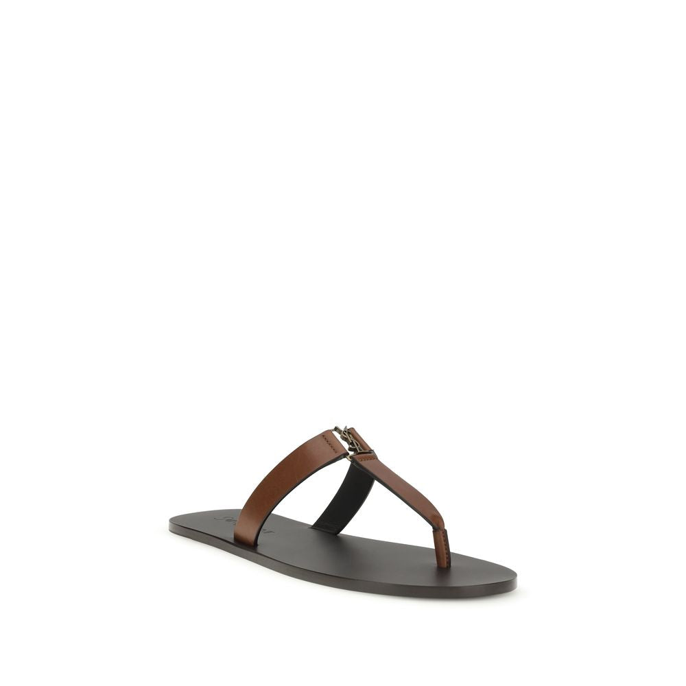Indulge in the exquisite Saint Laurent Brown Calf Leather Bos Taurus Flip-Flop Sandals, where unparalleled craftsmanship meets timeless elegance for discerning tastes.
