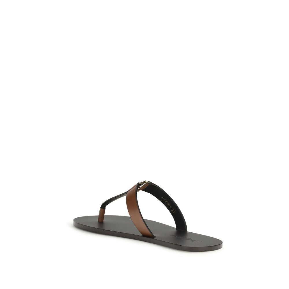 Indulge in the exquisite Saint Laurent Brown Calf Leather Bos Taurus Flip-Flop Sandals, where unparalleled craftsmanship meets effortless elegance for the discerning connoisseur.