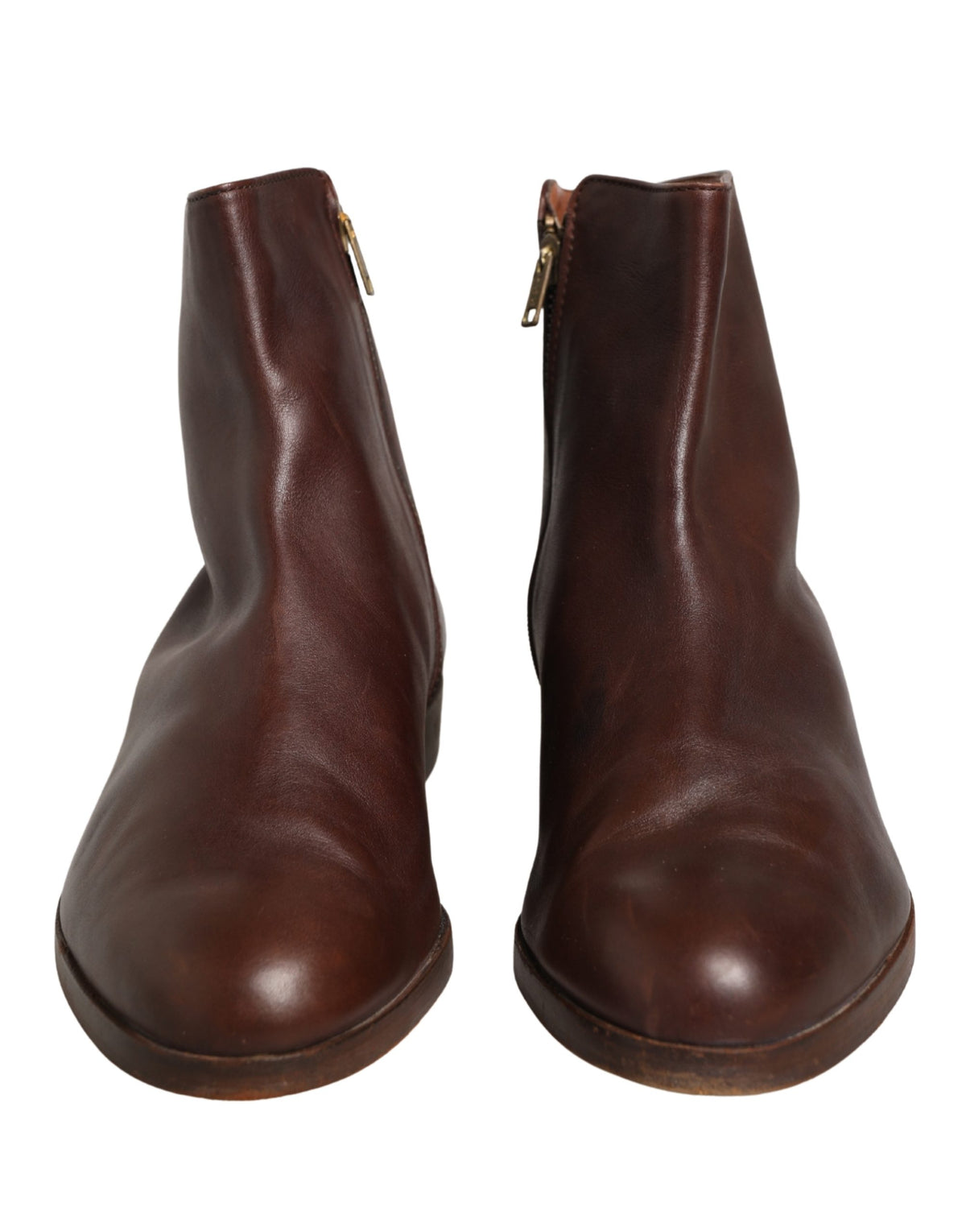 Experience the exquisite craftsmanship of Dolce & Gabbana's brown leather ankle boots, a timeless blend of elegance and versatility for the discerning connoisseur.