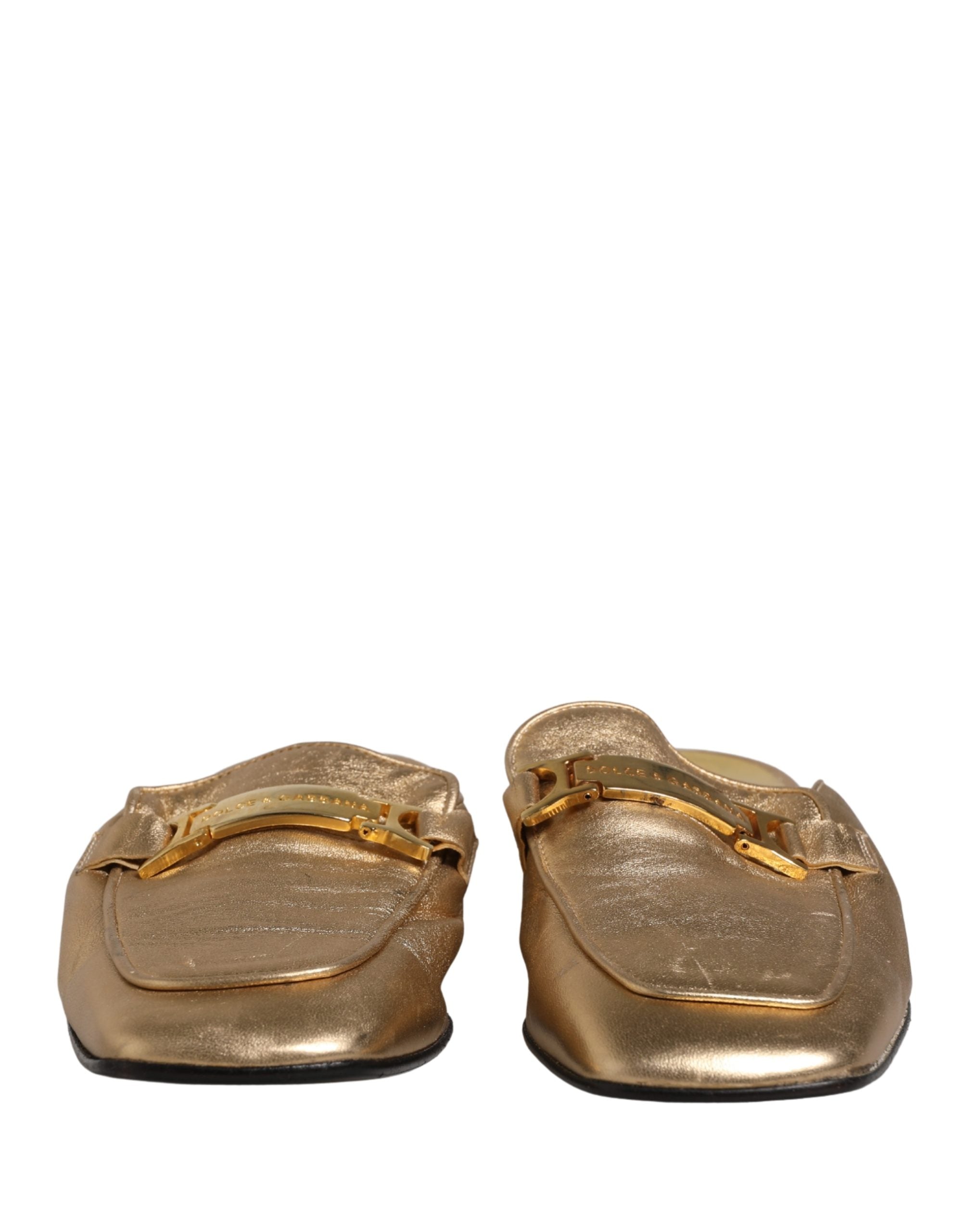 Experience the allure of Dolce & Gabbana's Gold Leather Flats, where Italian craftsmanship meets timeless elegance, perfect for elevating any sophisticated ensemble.