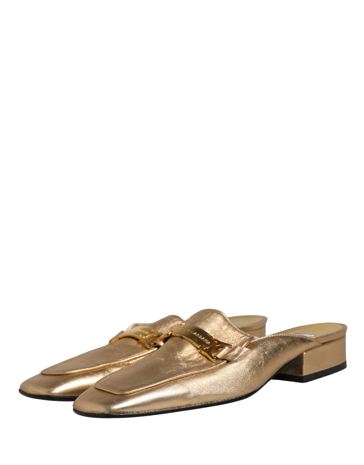 Experience the allure of Dolce & Gabbana's gold leather mule loafers, a timeless embodiment of Italian craftsmanship that elevates any ensemble with effortless elegance.