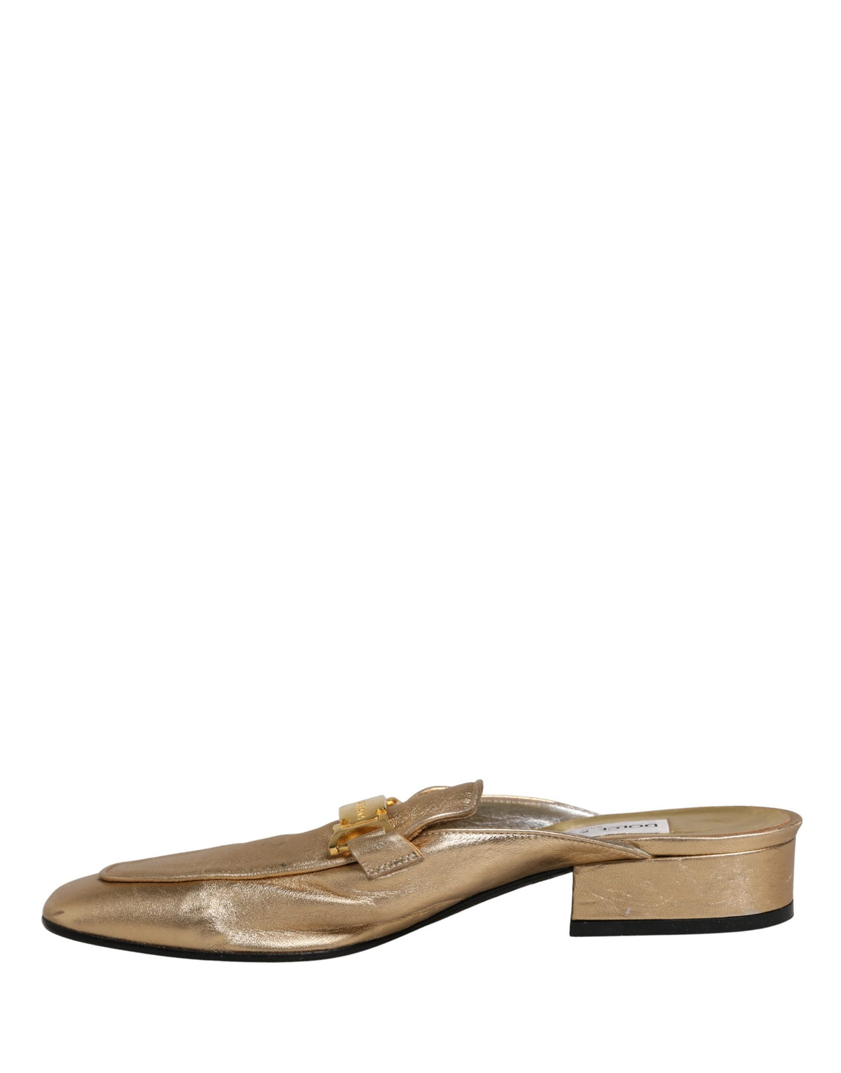 Experience the allure of Dolce & Gabbana's gold leather flats, where Italian craftsmanship meets timeless elegance, perfect for elevating any sophisticated ensemble.