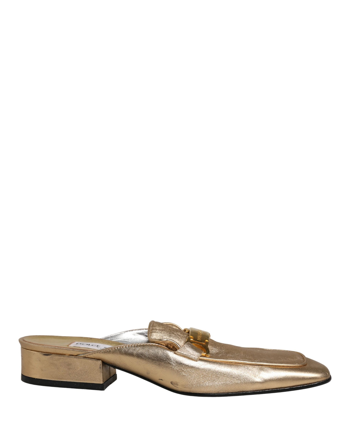 Step into a realm of elegance with Dolce & Gabbana's gold leather mule loafers, where Italian craftsmanship meets timeless luxury for the discerning connoisseur.