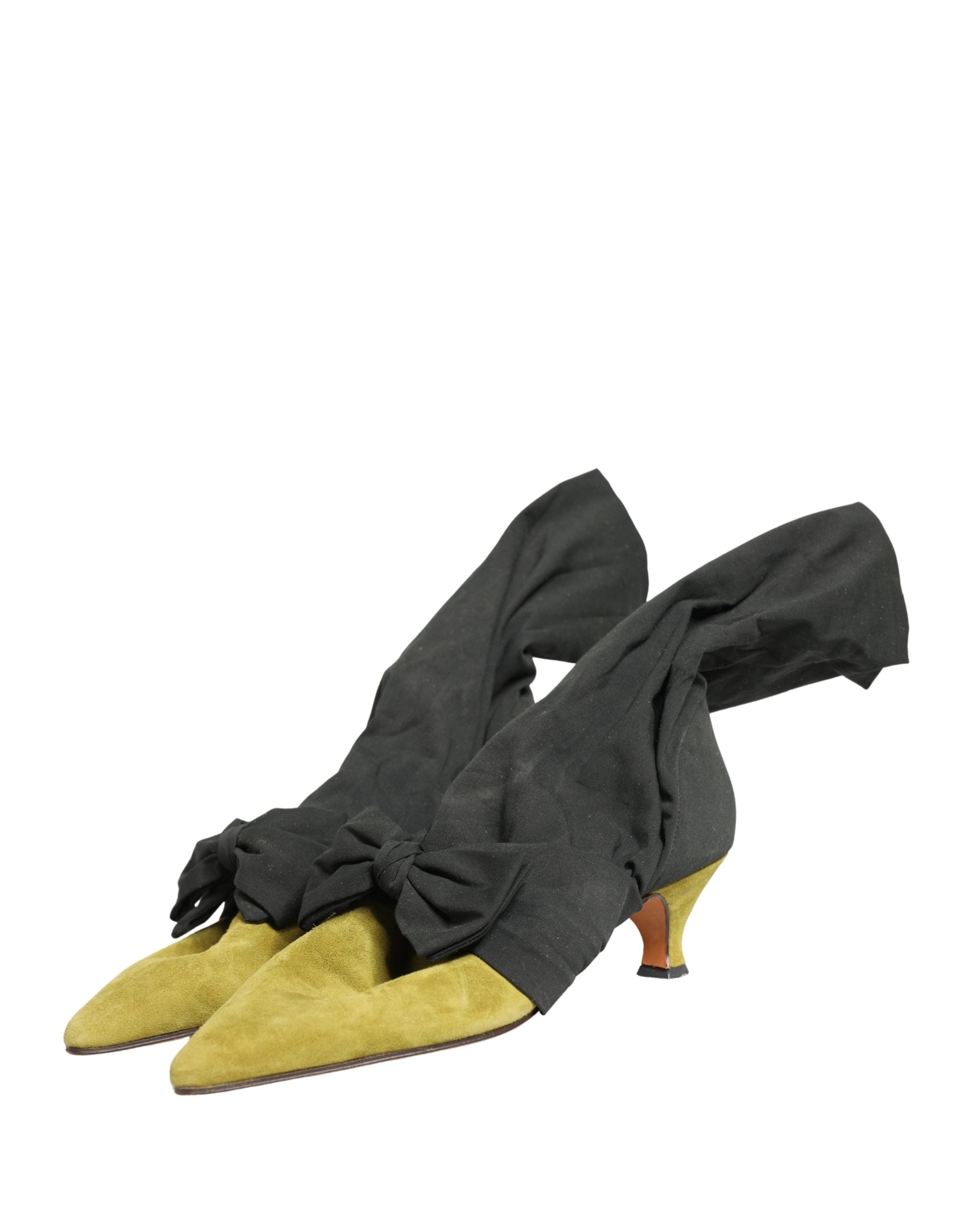 Step into a world of elegance with Dolce & Gabbana's Black Yellow Suede Mid Calf Boots, where exquisite craftsmanship meets bold luxury, perfect for the discerning fashionista.