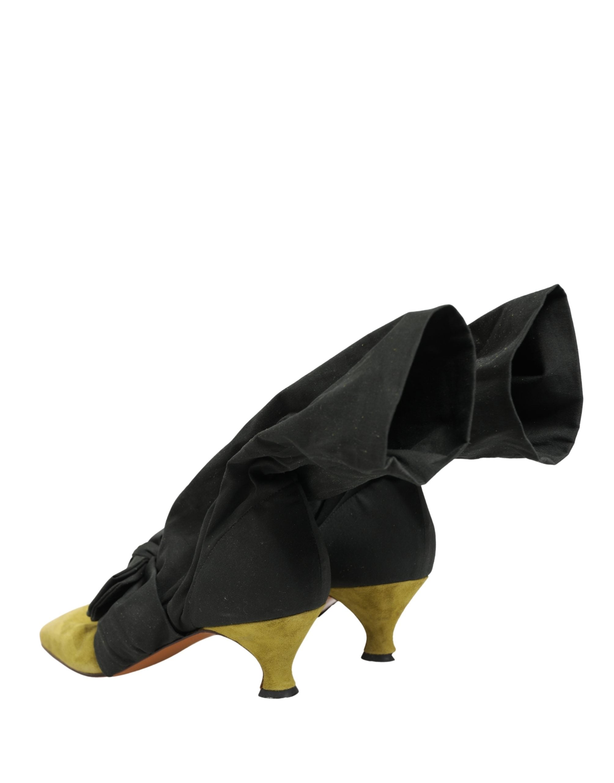 Step into a world of opulence with Dolce & Gabbana's Black Yellow Suede Mid Calf Boots, where exquisite craftsmanship meets bold elegance, perfect for the discerning fashionista.