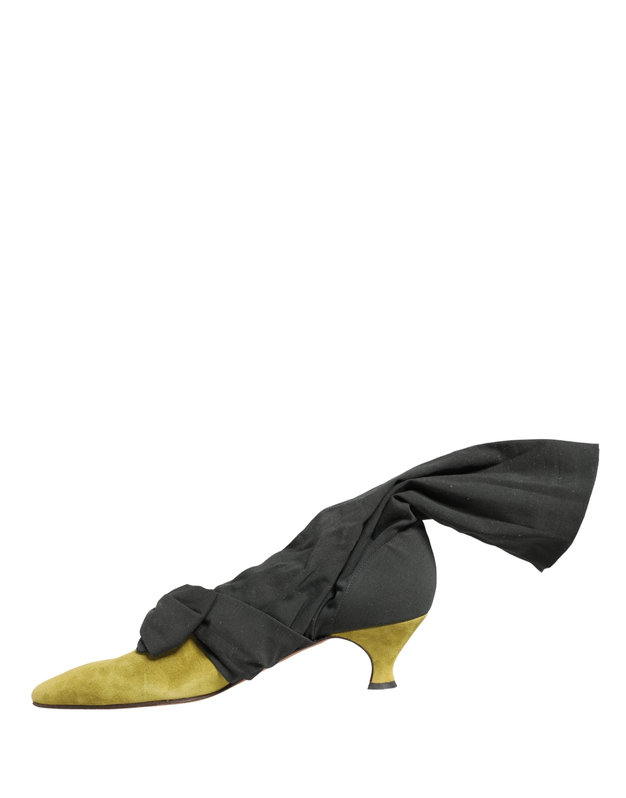 Step into a world of elegance with Dolce & Gabbana's Black Yellow Suede Mid Calf Boots, where Italian craftsmanship meets bold artistry, perfect for the discerning fashionista.
