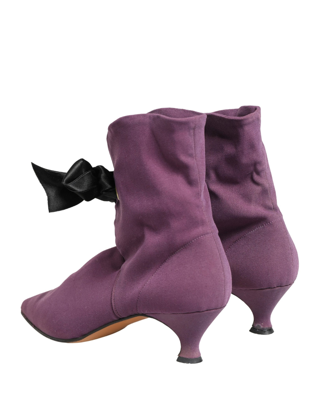 Step into a realm of refined elegance with Dolce & Gabbana's Purple Mid Calf Boots, crafted from sumptuous suede, embodying Italian luxury and timeless sophistication.