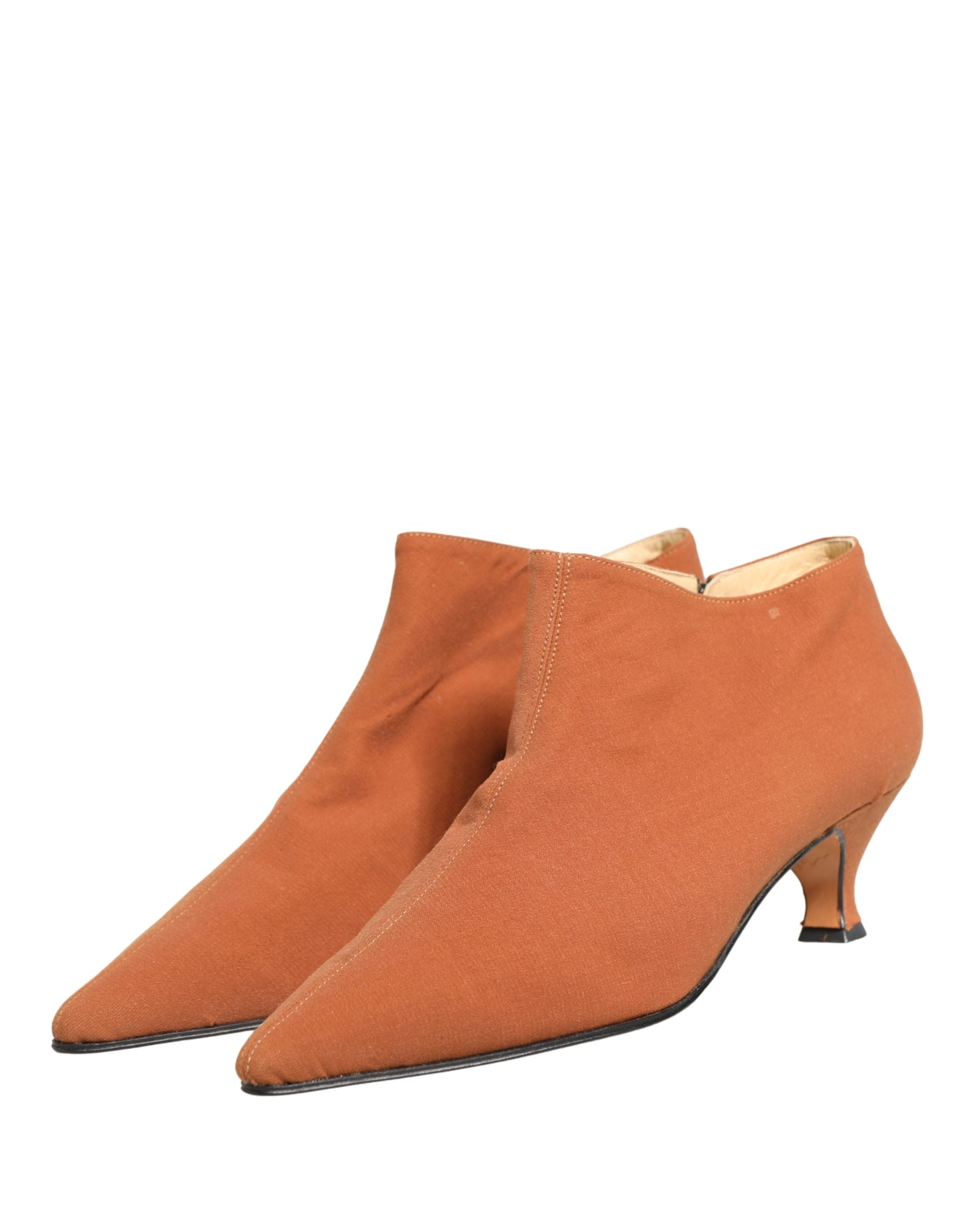 Experience the exquisite Dolce & Gabbana Brown Suede Ankle Boots, a symbol of Italian craftsmanship that elevates your style with timeless elegance and allure.