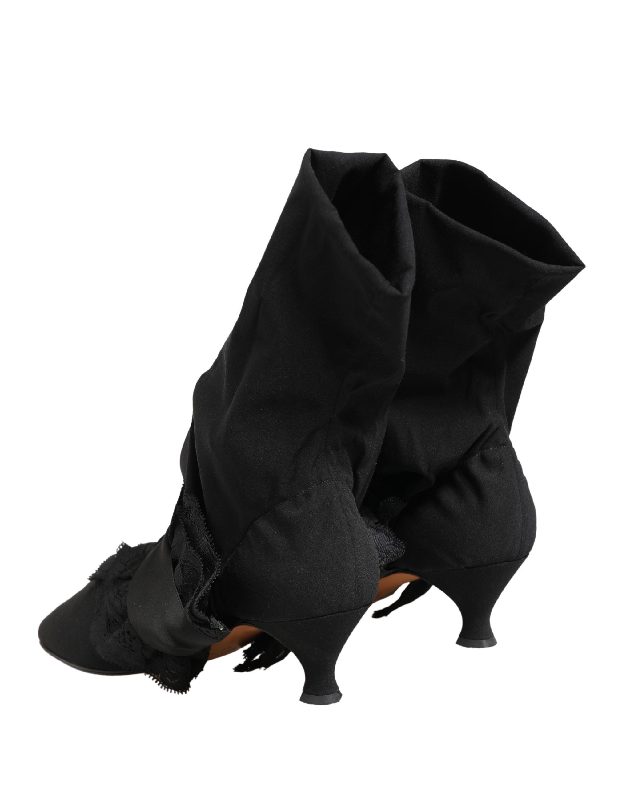 Experience the allure of Dolce & Gabbana's Black Suede Mid Calf Boots, where exquisite craftsmanship meets timeless elegance, elevating your style to new heights.