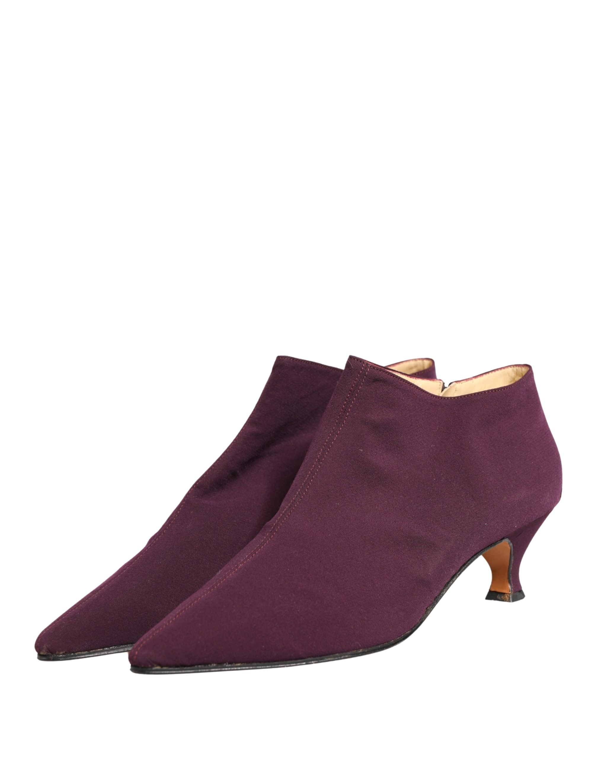 Indulge in the exquisite Dolce & Gabbana Purple Suede Ankle Boots, a testament to Italian craftsmanship that elevates your style with luxurious allure and sophistication.