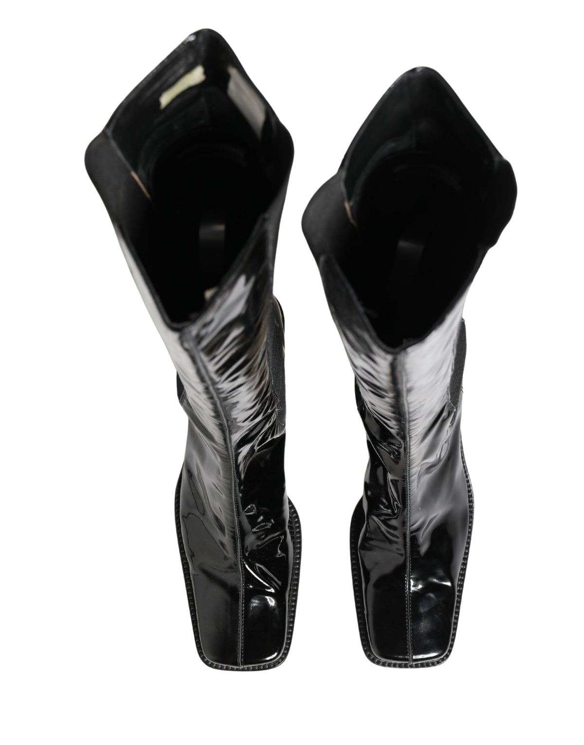 Elevate your style with Dolce & Gabbana's Black Patent Leather Knee High Boots, where exquisite Italian craftsmanship meets timeless elegance for the discerning fashionista.