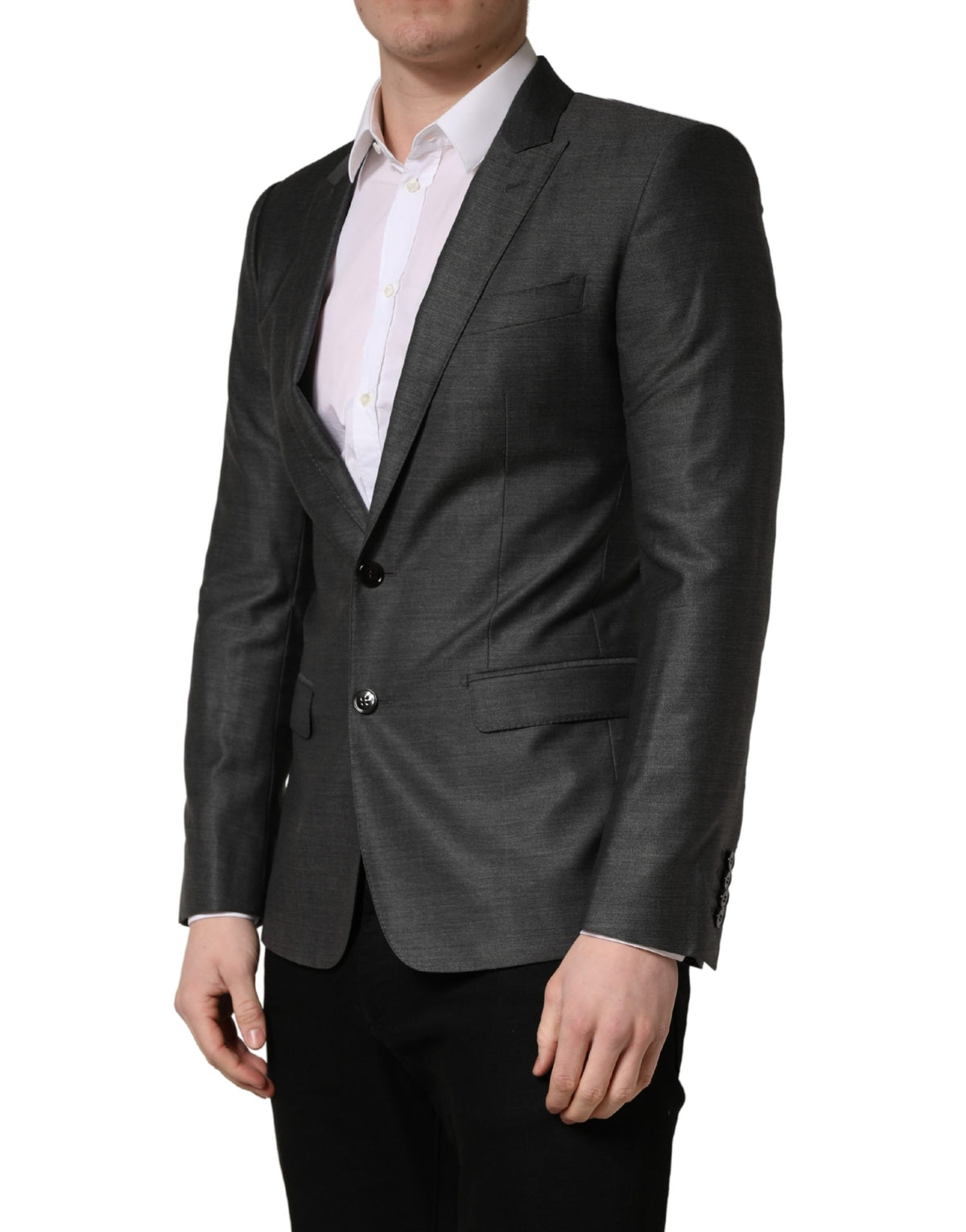 Elevate your style with the Dolce & Gabbana Dark Gray Wool Slim Fit Blazer, a masterpiece of Italian craftsmanship, blending luxurious materials for timeless elegance.