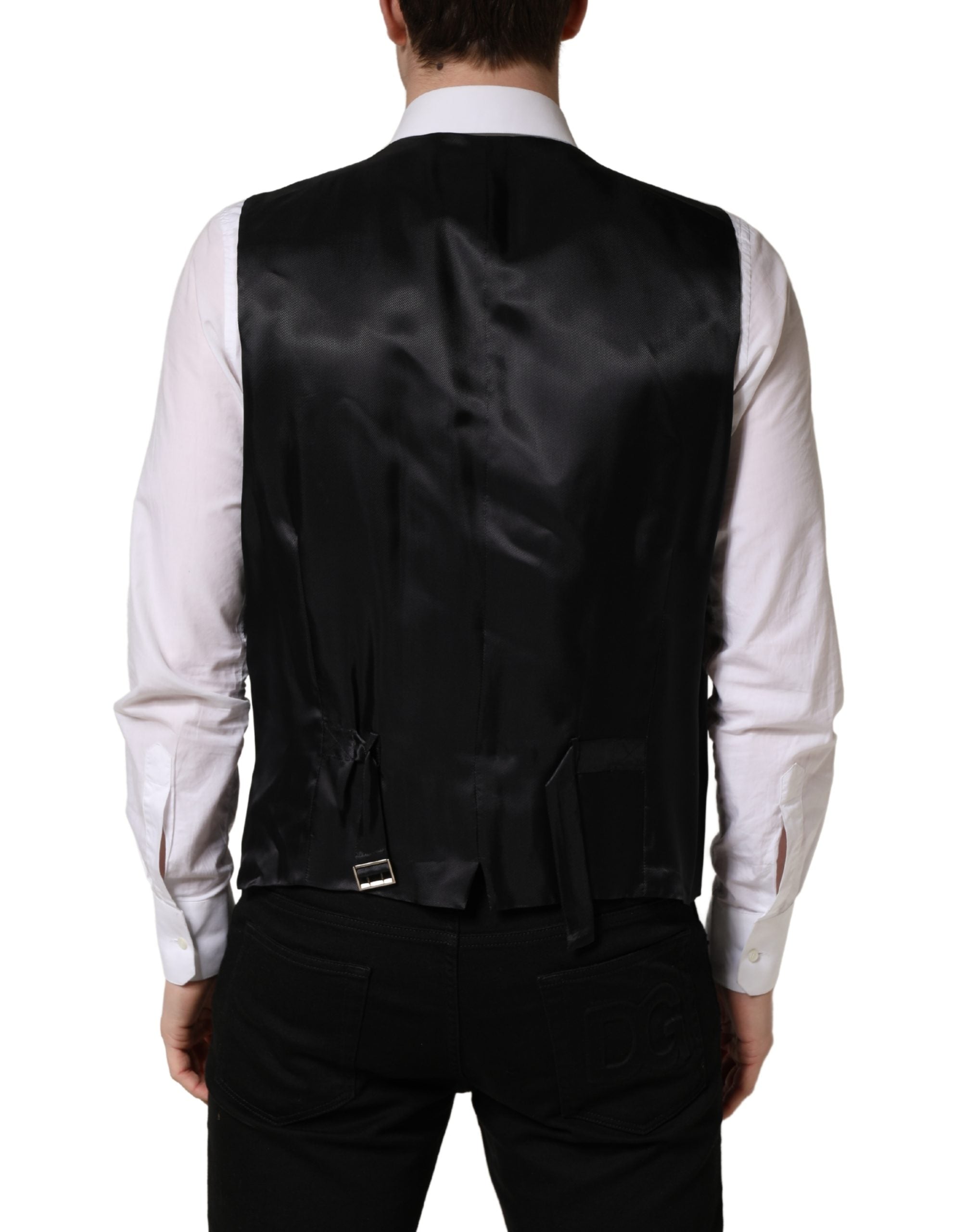 Elevate your elegance with the Dolce & Gabbana Black Wool Single Breasted Waistcoat, a masterpiece of Italian craftsmanship that embodies timeless luxury and sophistication.