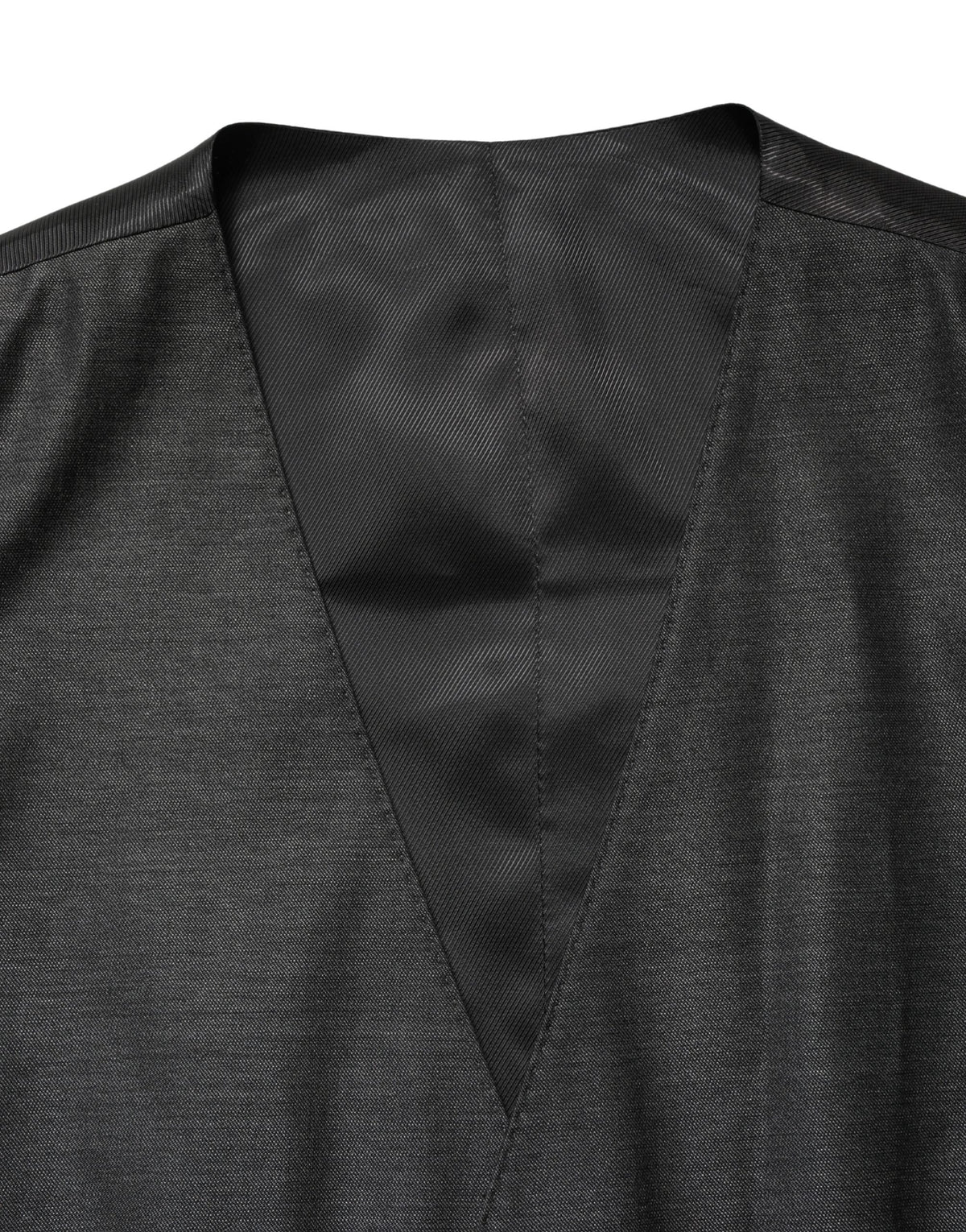 Elevate your elegance with the Dolce & Gabbana Dark Gray Wool Dress Formal Waistcoat Vest, a masterpiece of Italian craftsmanship blending luxurious wool and silk for timeless sophistication.