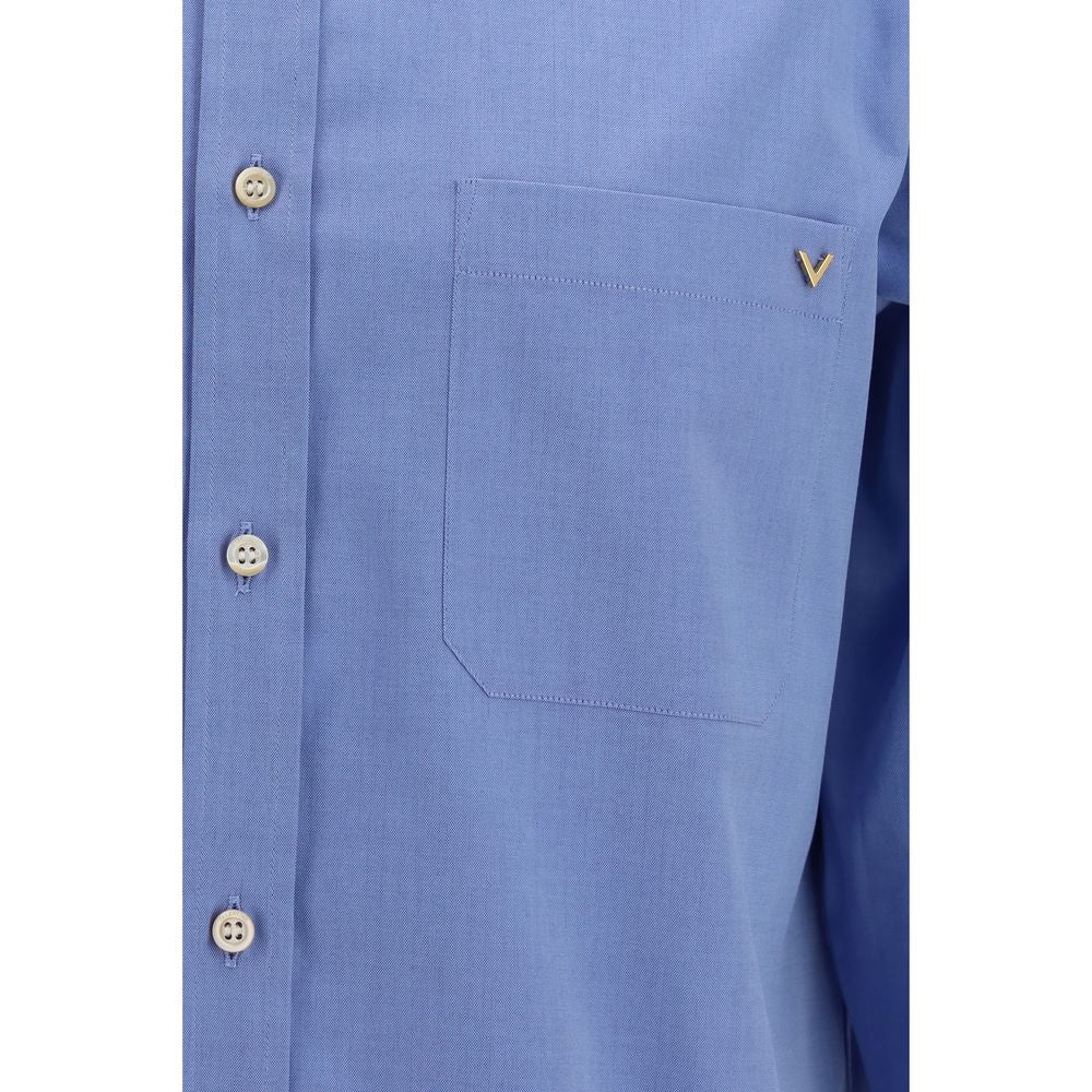 Experience the allure of the Valentino Blue Cotton Shirt, crafted from luxurious lightweight cotton, embodying elegance and sophistication for every occasion.