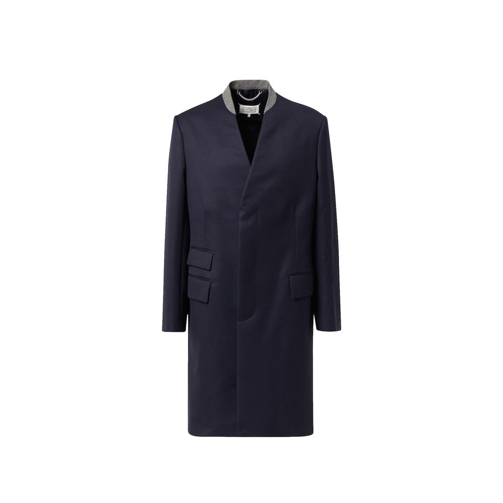 Indulge in the Maison Margiela Blue Wool Coat, a masterpiece of Italian craftsmanship, exuding elegance and warmth for the discerning individual seeking timeless luxury.