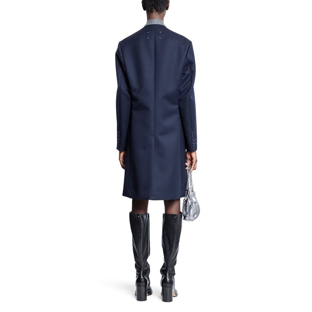 Indulge in the Maison Margiela Blue Wool Coat, a masterpiece of Italian craftsmanship, enveloping you in luxurious warmth and timeless elegance for any occasion.