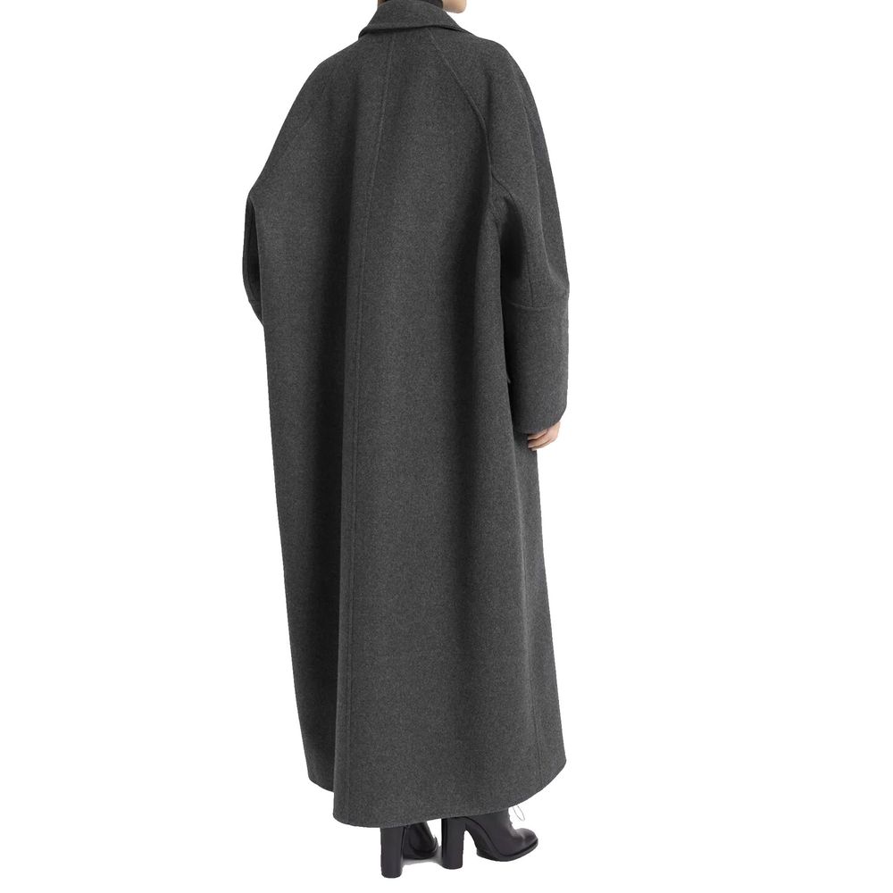 Experience the epitome of elegance with the Max Mara Gray Cashmere Coat, crafted from a sumptuous blend of cashmere and wool, embodying timeless sophistication for the discerning individual.