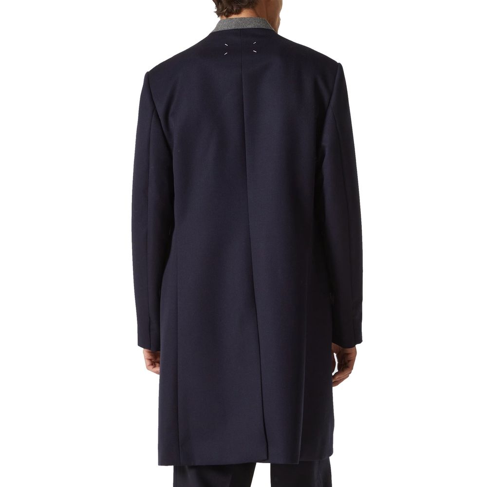Discover the Maison Margiela Blue Wool Coat, a masterful blend of 100% premium wool and Italian craftsmanship, embodying timeless elegance for the discerning individual.