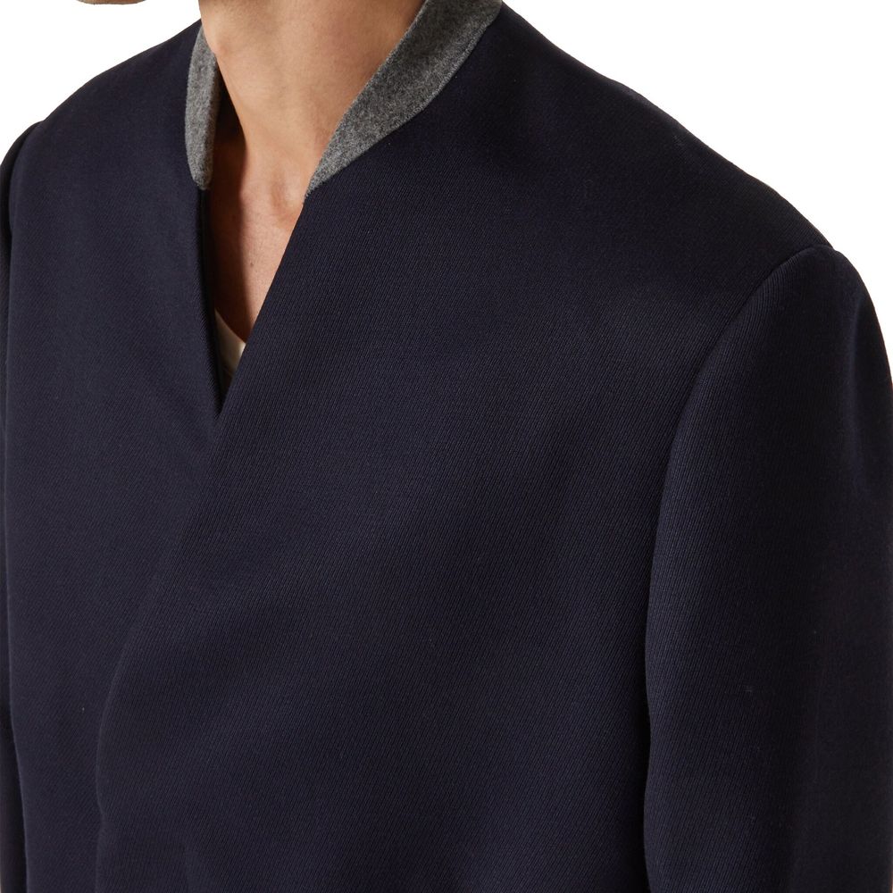 Discover the Maison Margiela Blue Wool Coat, a masterpiece of Italian craftsmanship in 100% premium wool, embodying timeless elegance for the discerning individual.