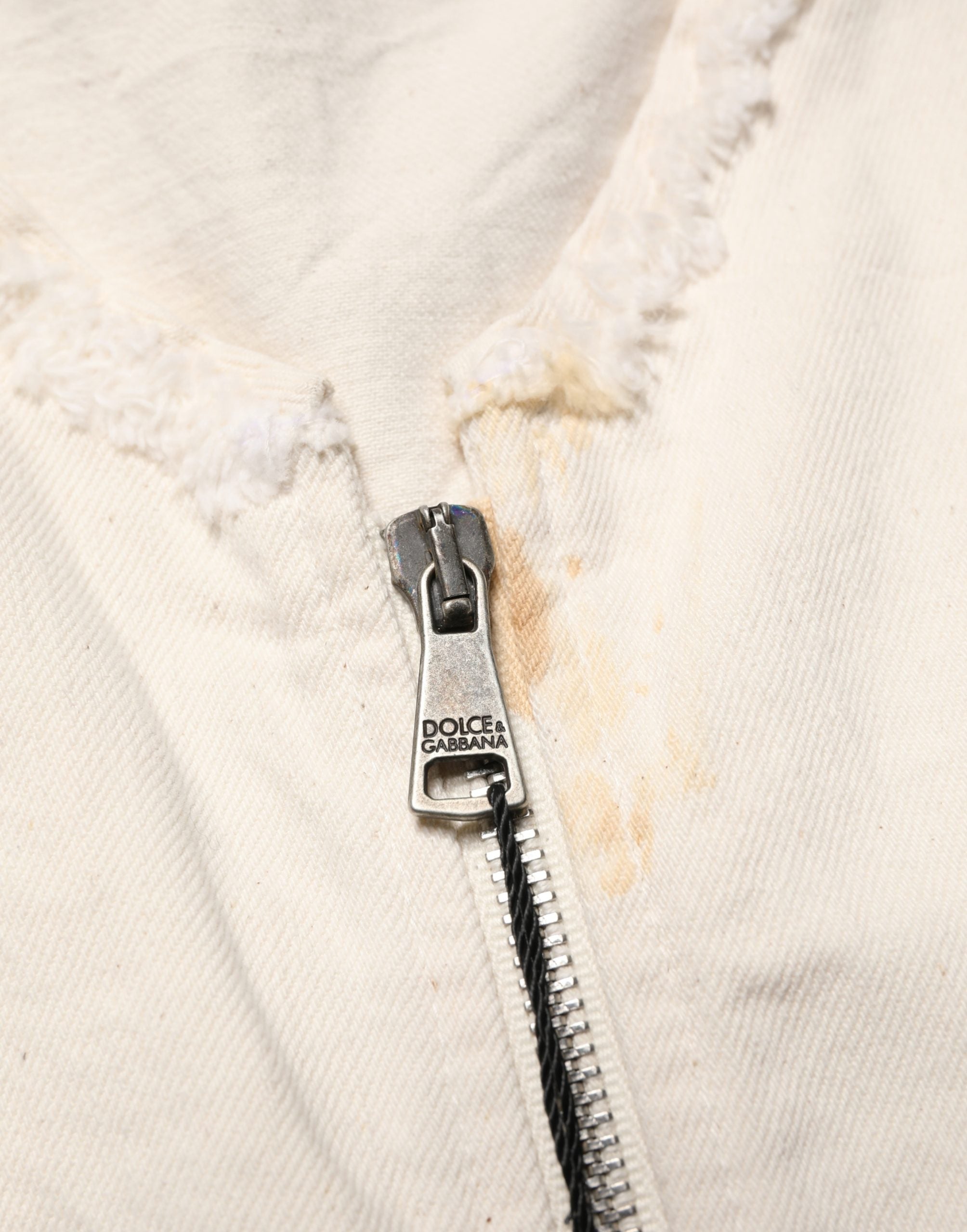 Indulge in the exquisite Dolce & Gabbana Off White Cotton Full Zip Denim Blouson Jacket, where luxurious craftsmanship meets timeless elegance, perfect for the discerning fashion connoisseur.